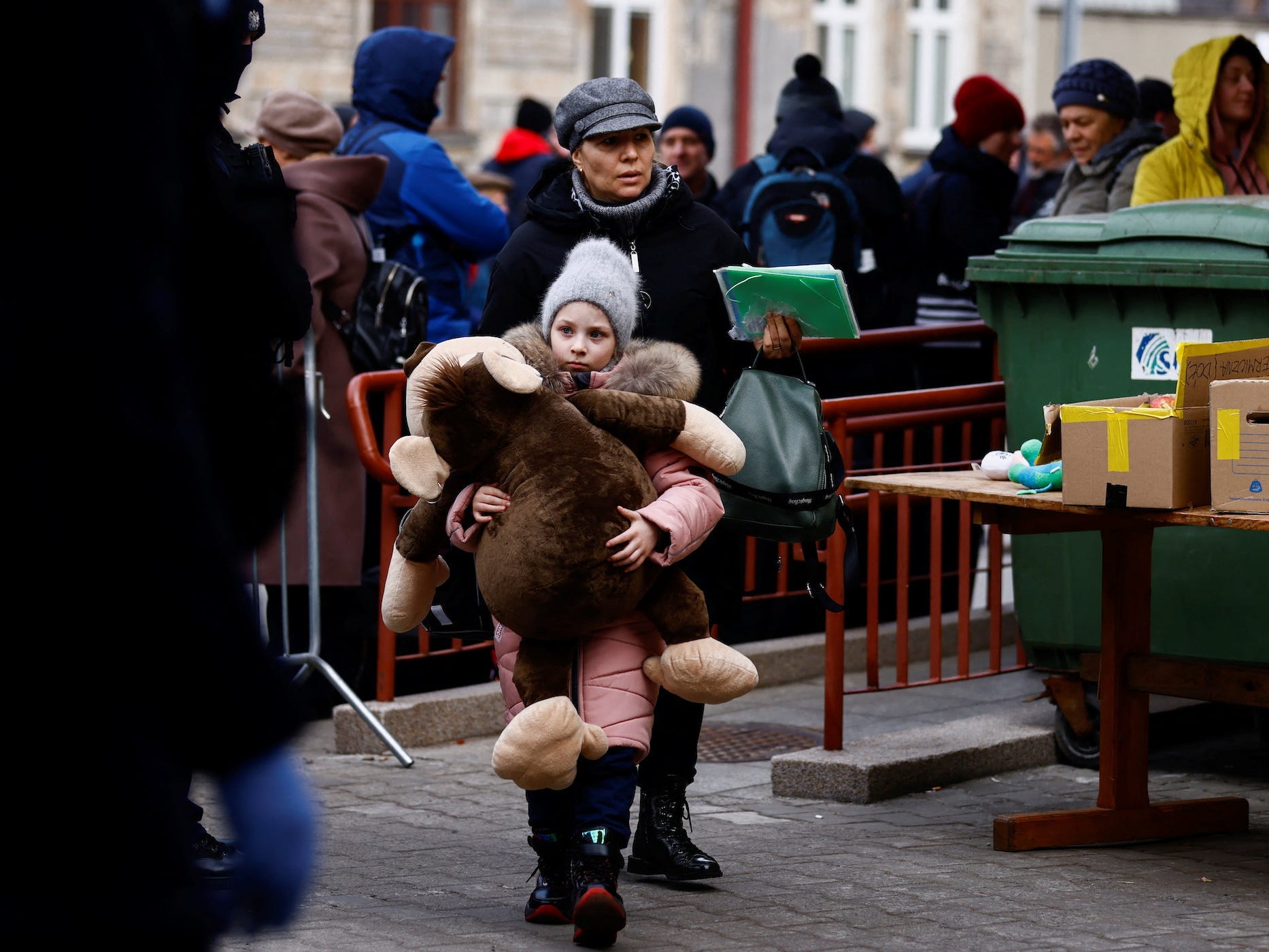 Child holds a plush toy as a Ukrainian train transporting hundreds of people fleeing from the Russian invasion of Ukraine arrives at the train station in Przemysl, Poland