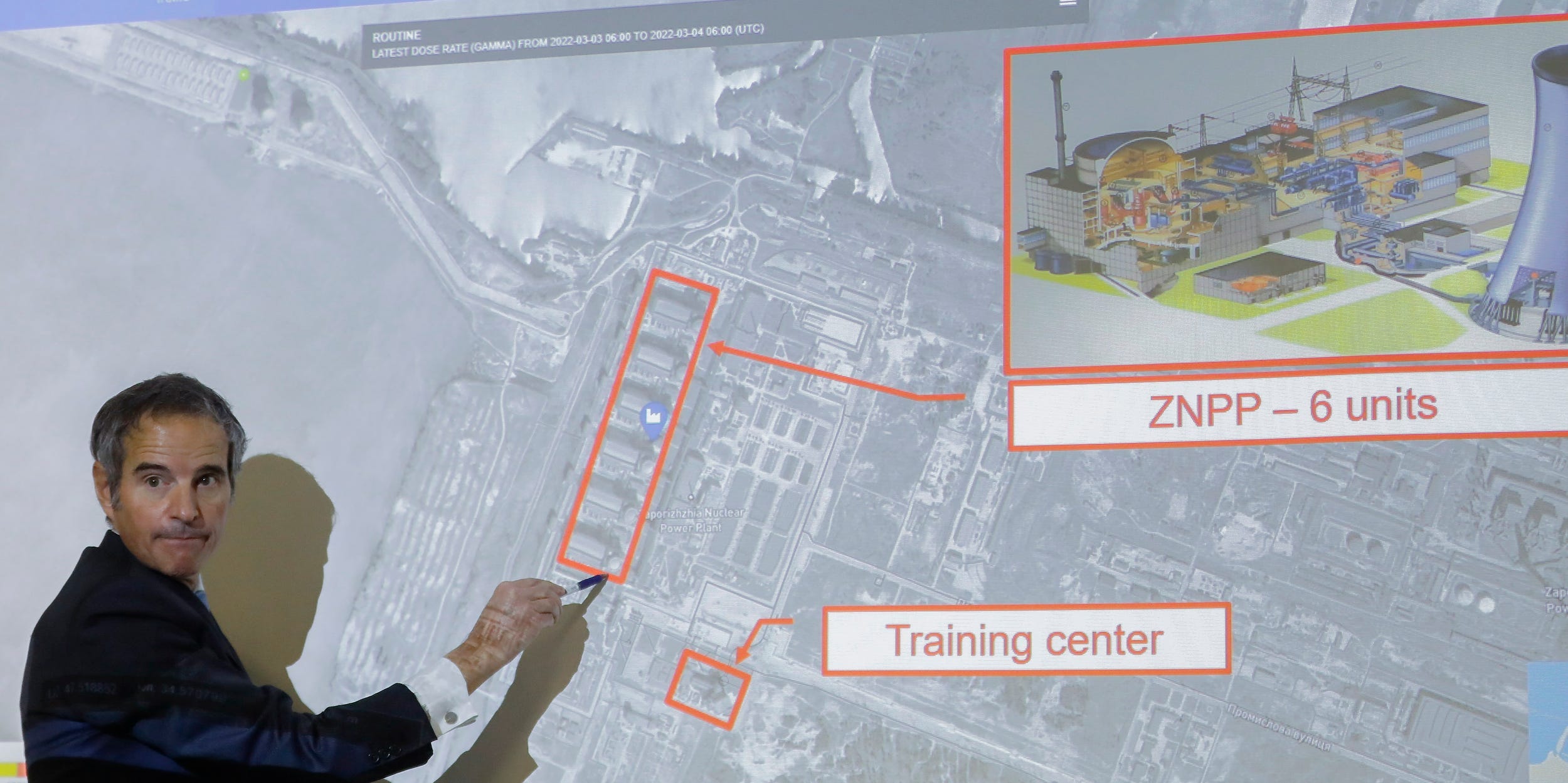 Rafael Mariano Grossi points to a diagram showing the Zaporizhzhia Nuclear Power Plant in Ukraine