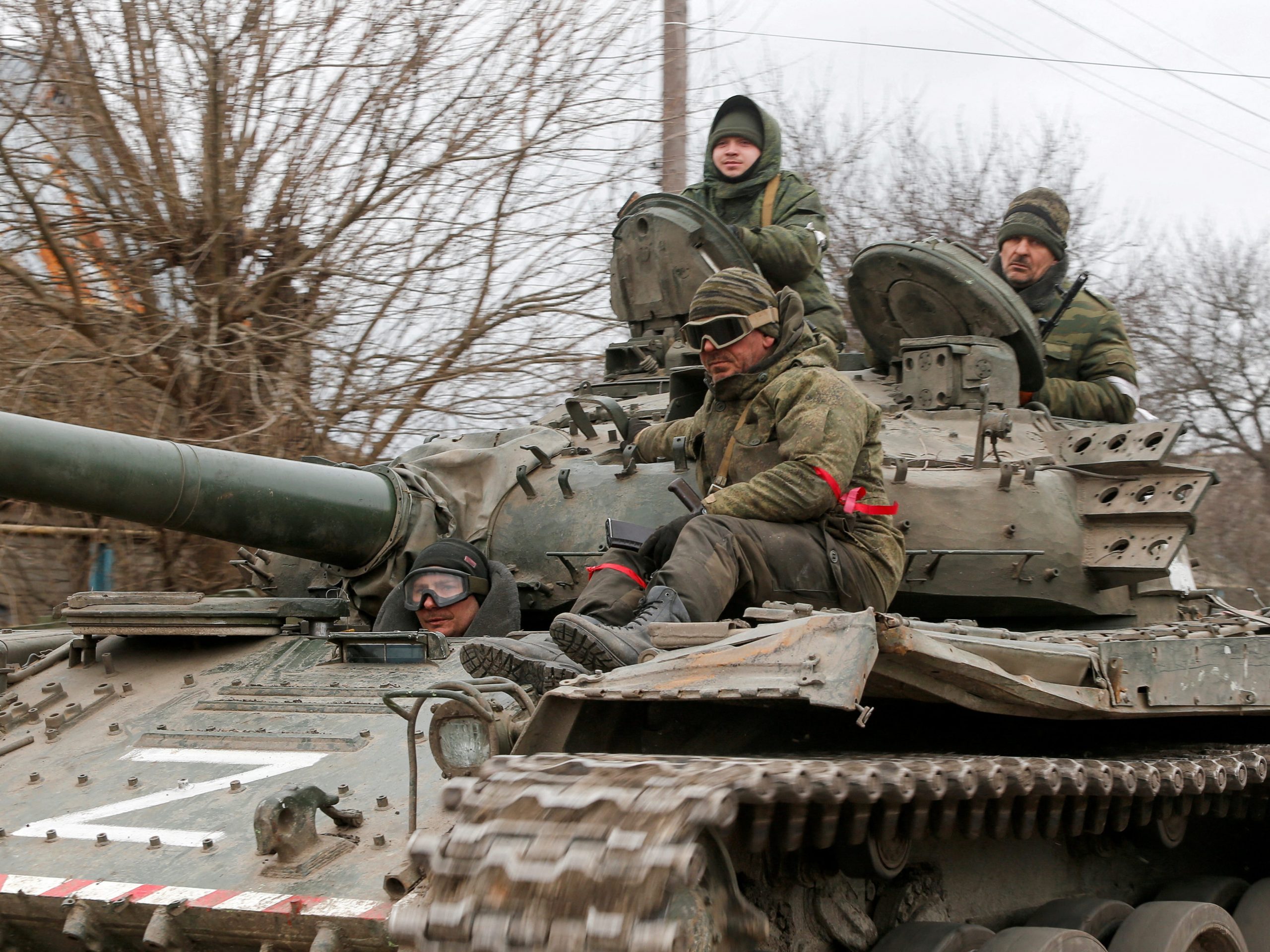 Service members of pro-Russian troops in uniforms without insignia are seen atop of a tank with the letter "Z" painted on its sides in the separatist-controlled settlement of Buhas (Bugas), as Russia's invasion of Ukraine continues, in the Donetsk region, Ukraine March 1, 2022.