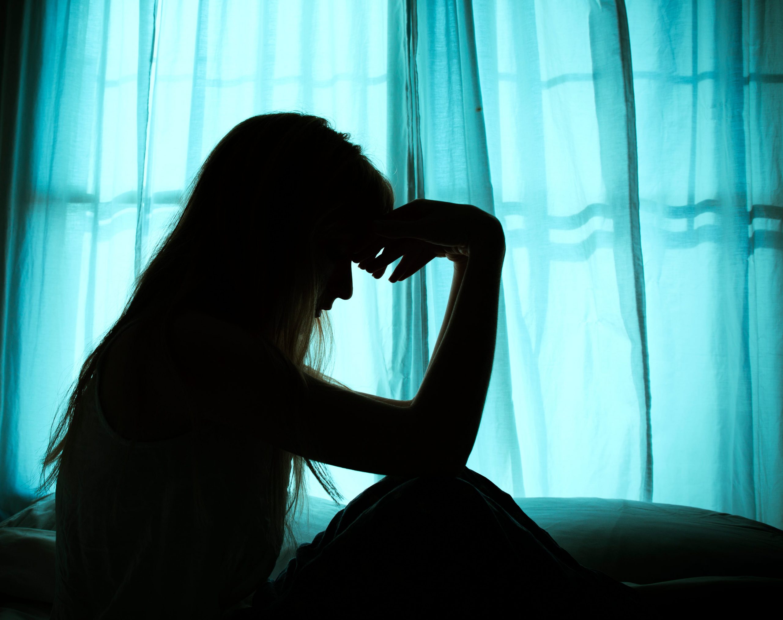 woman holding head silhouette