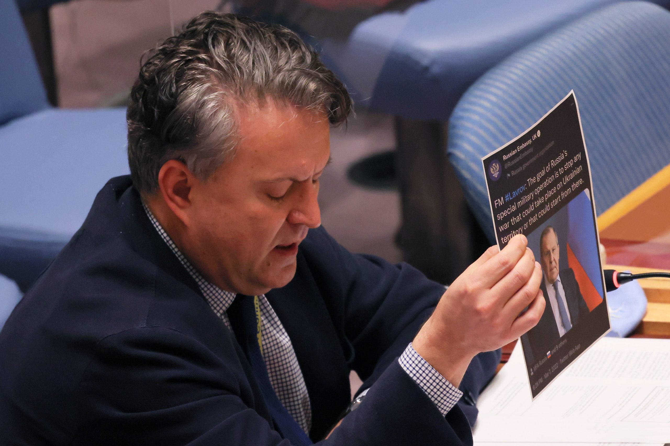 Sergiy Kyslytsya, United Nations permanent representative of Ukraine, holds up a printout of a retweet of Russian Foreign Minister Sergei Lavrov.