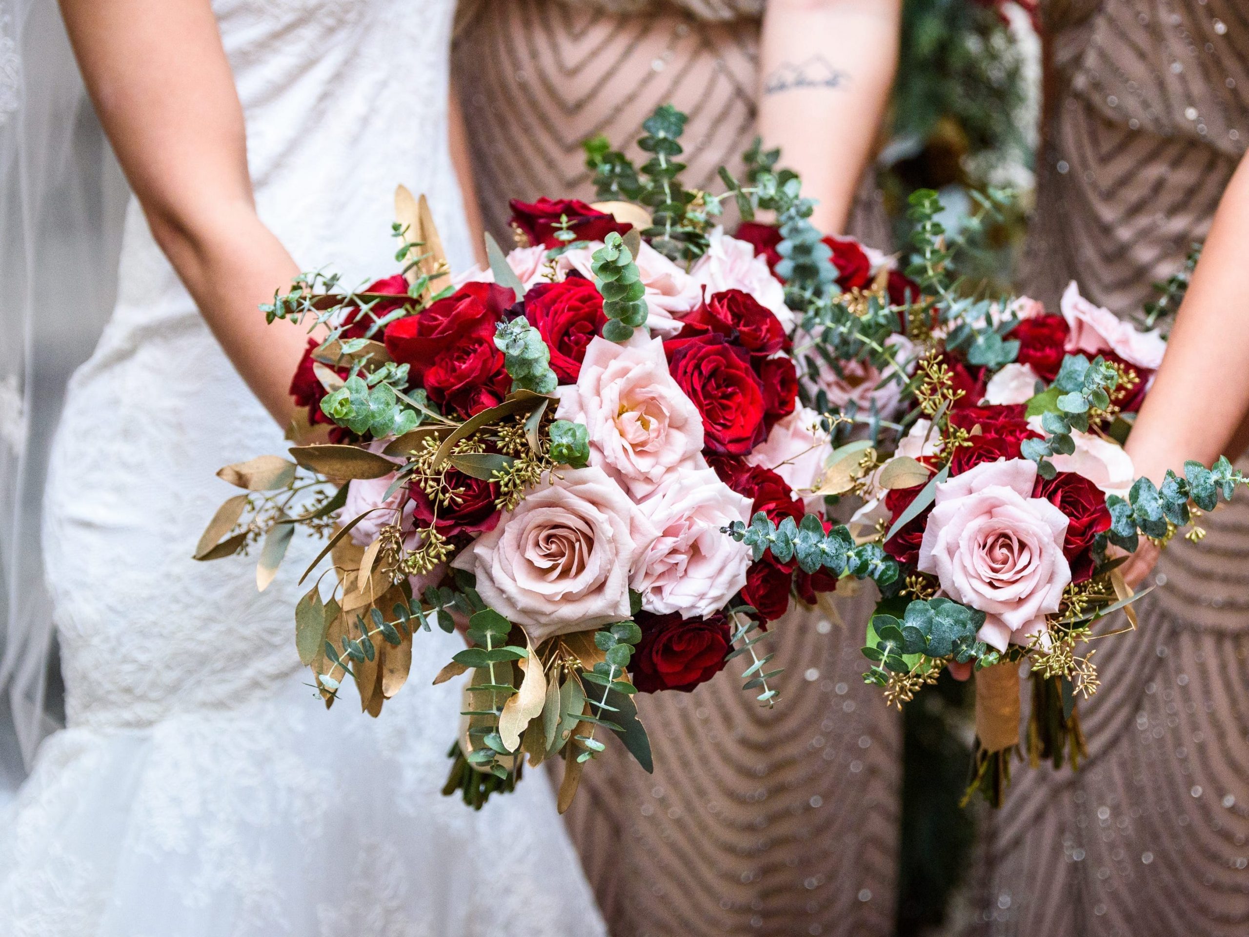 bride and bridesmaids holding their flowers together