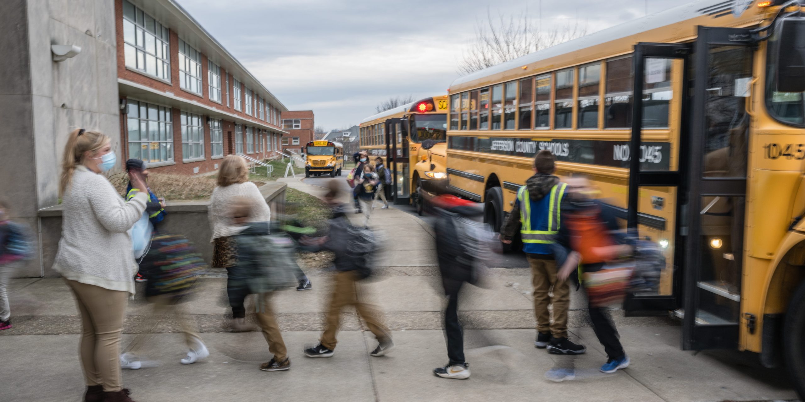 teacher seeing students off a school bus covid teaching burnout education