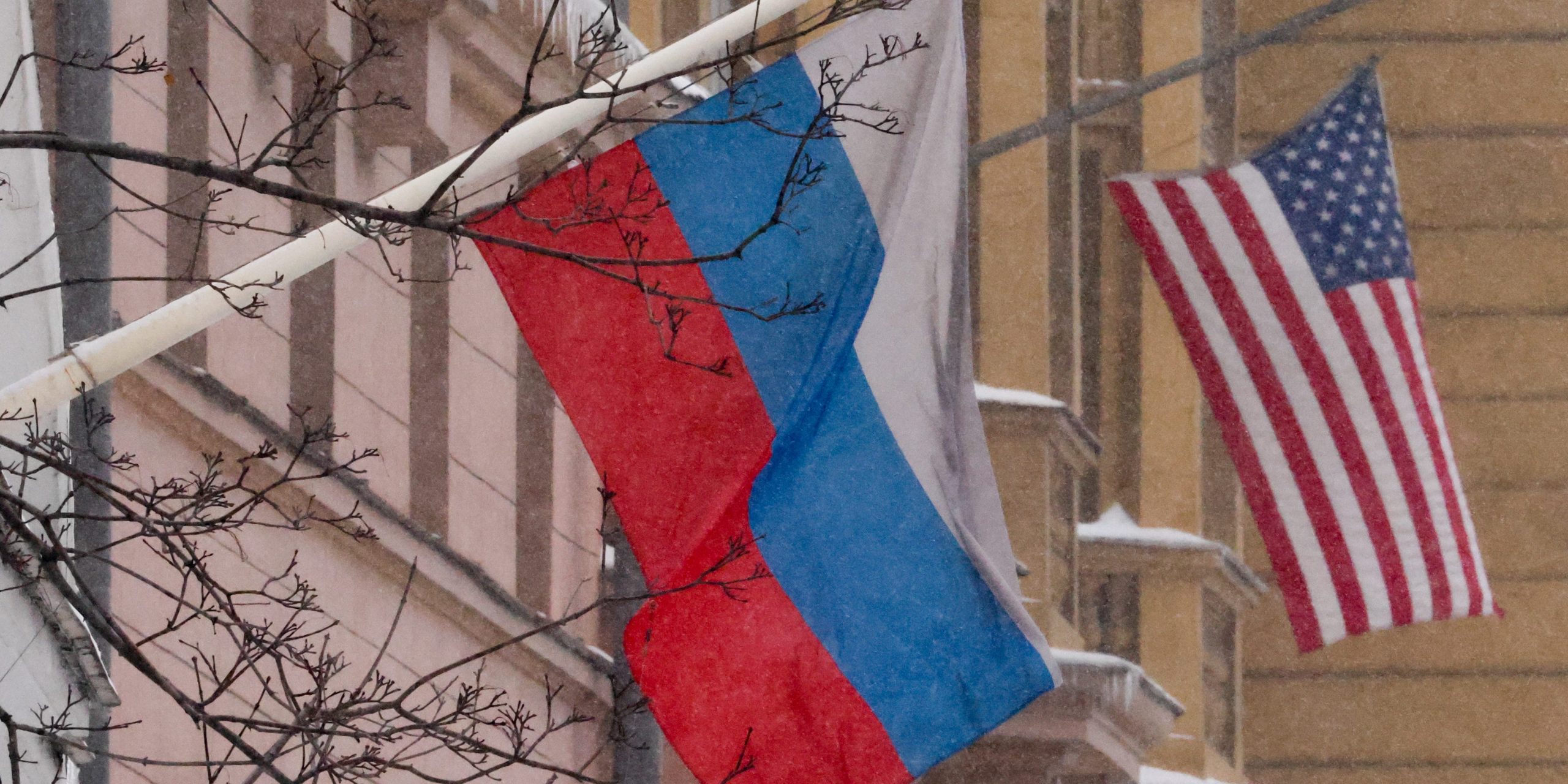 A Russian flag and American flag outside a building.