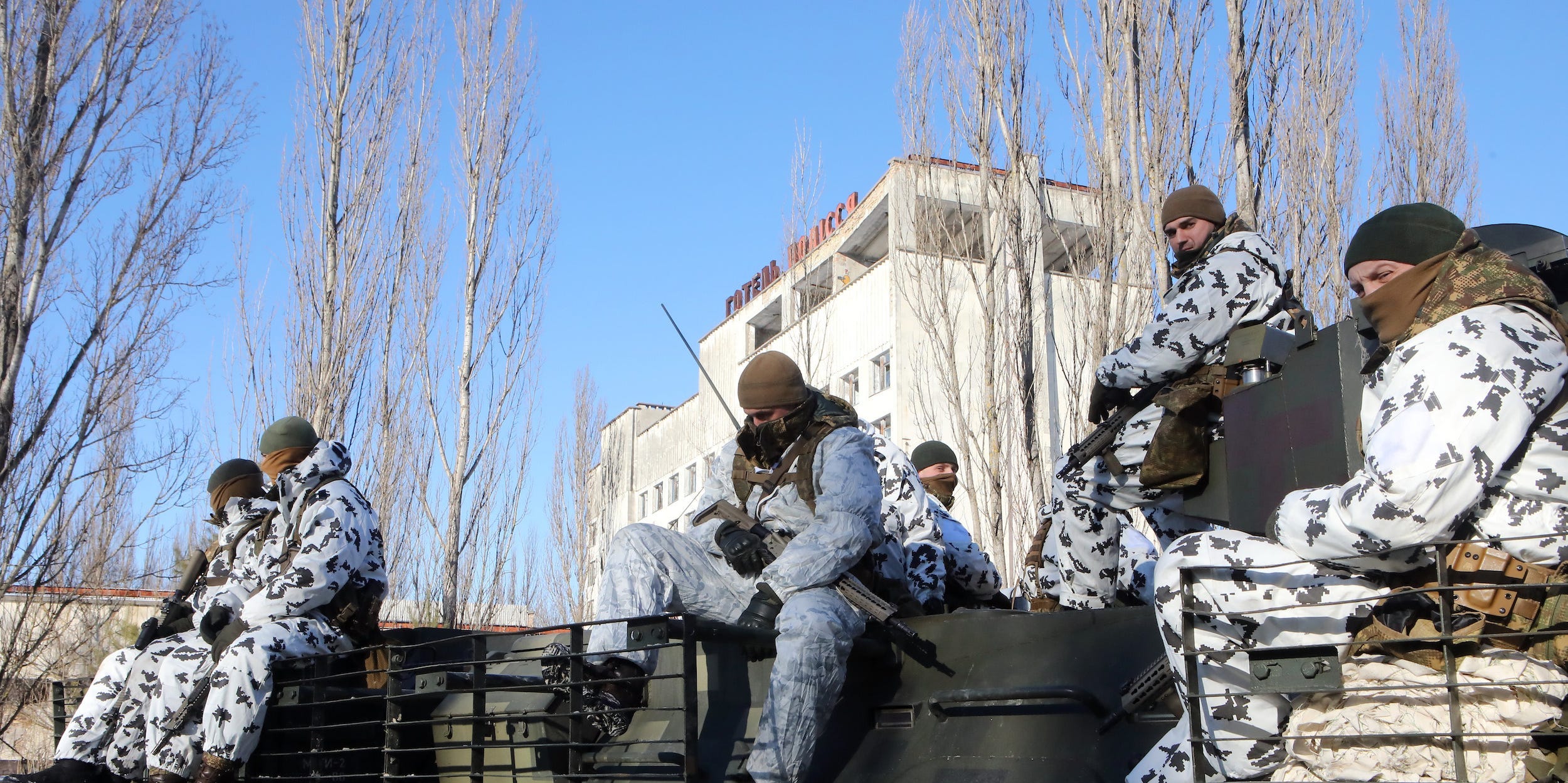 Soldiers sit inside the Chernobyl Exclusion Zone