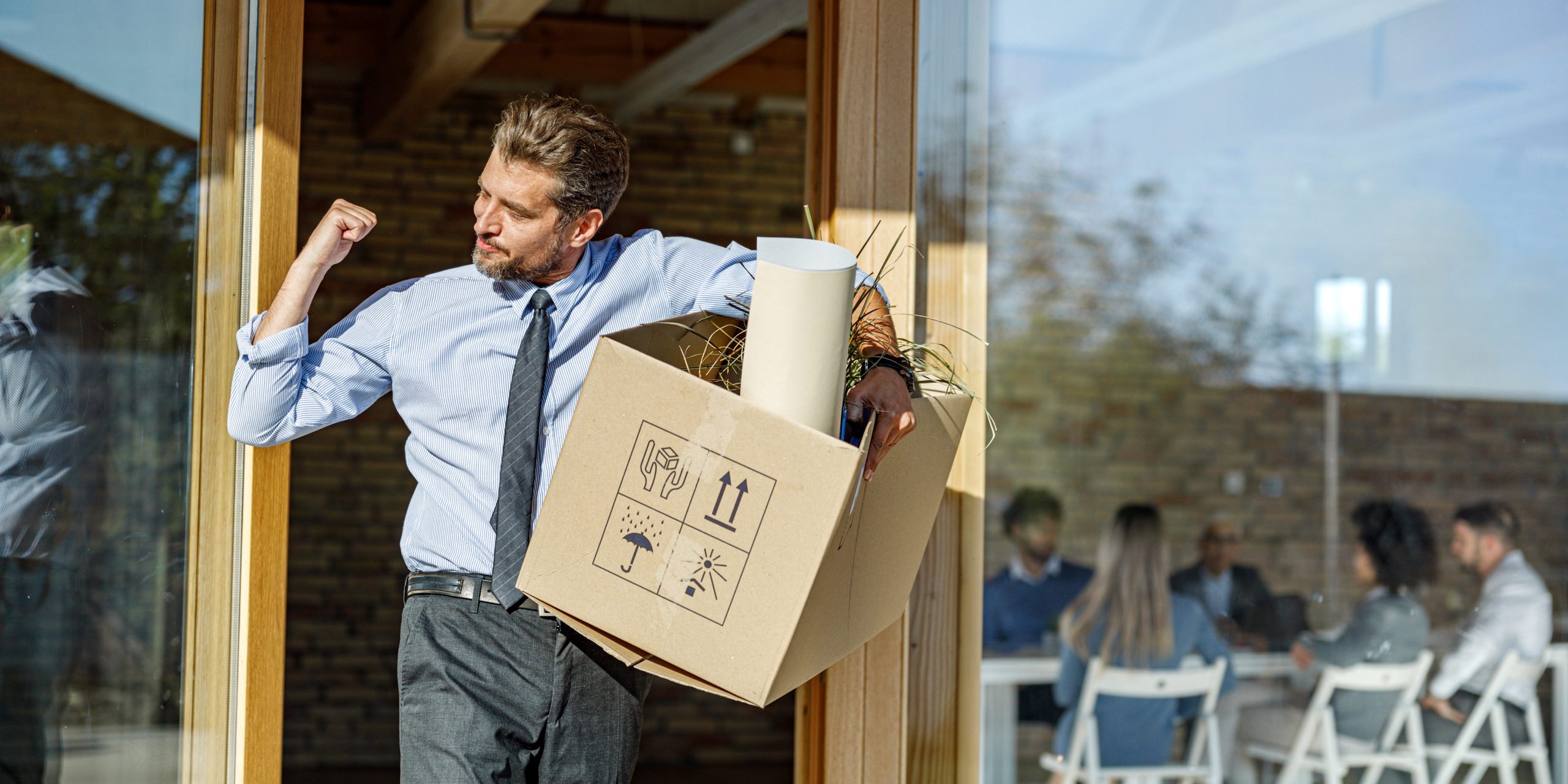 Businessman celebrating quitting his job and leaving the office.