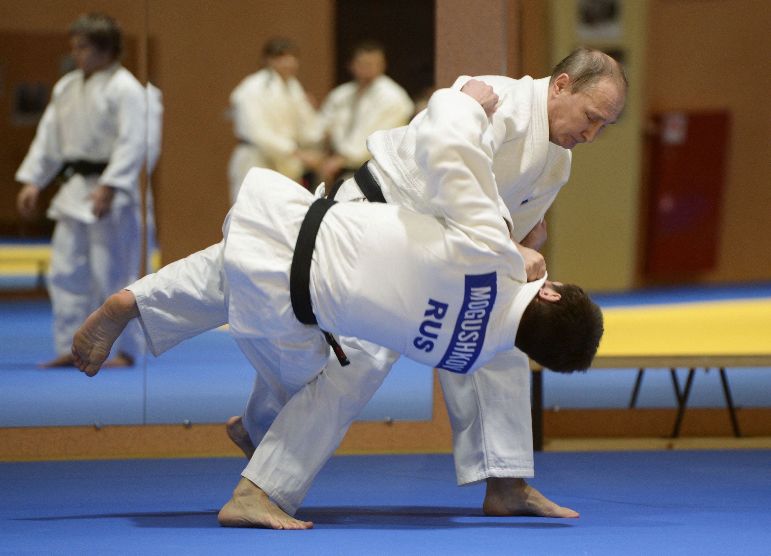Russian President Vladimir Putin (R) takes part in a judo training session