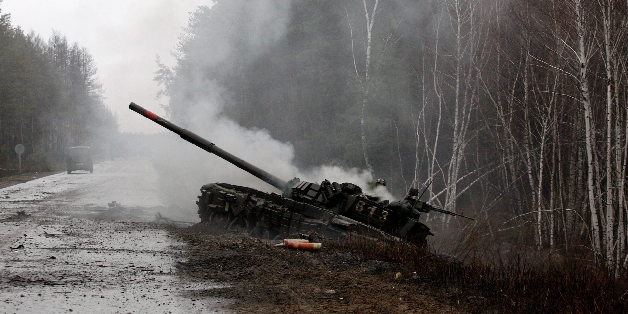 Smoke rises from a Russian tank damaged during the early days of Putin's invasion of Ukraine.