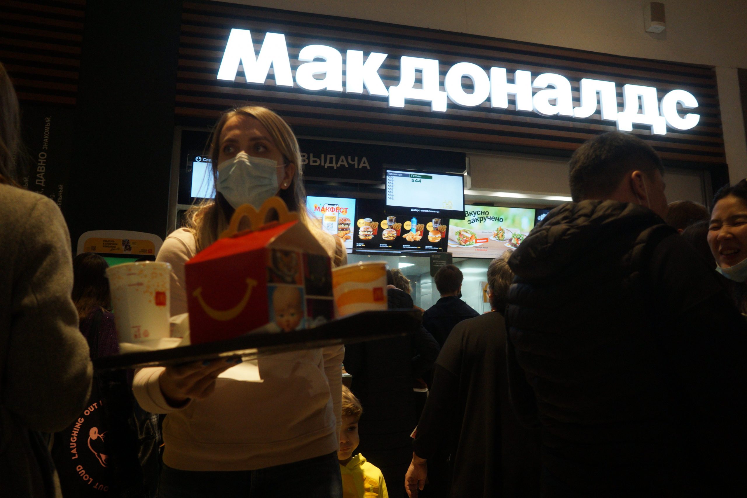 A woman holds a tray laden with food from McDonald's at one of the chain's Moscow locations