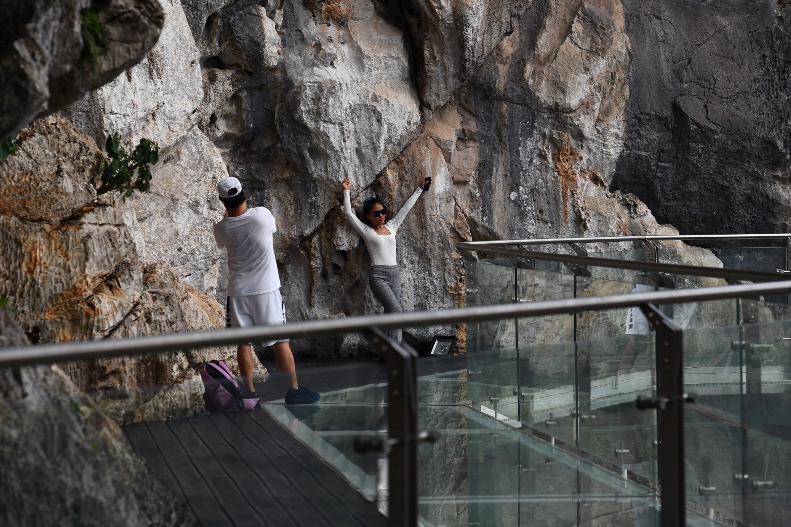 people stand on the Bach Long glass bridge in the Moc Chau district in Vietnam&#39;s Son La province