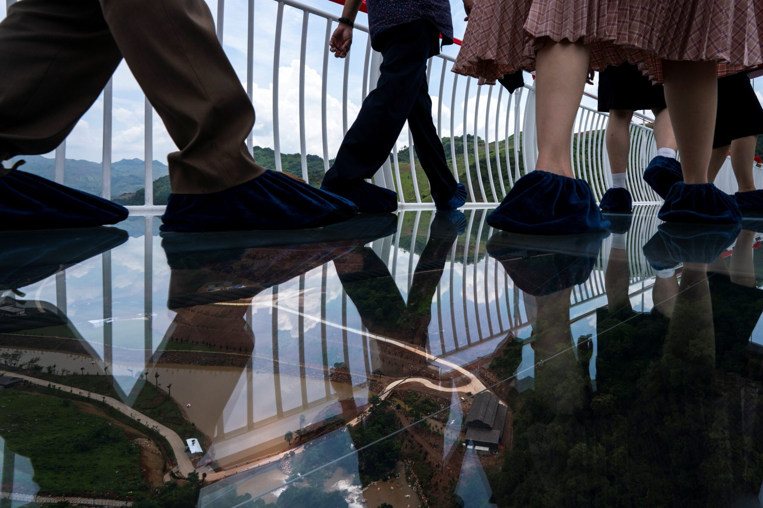 People walk on the Bach Long glass bridge during the opening ceremony at Moc Chau district in Son La province, Vietnam, May 28, 2022