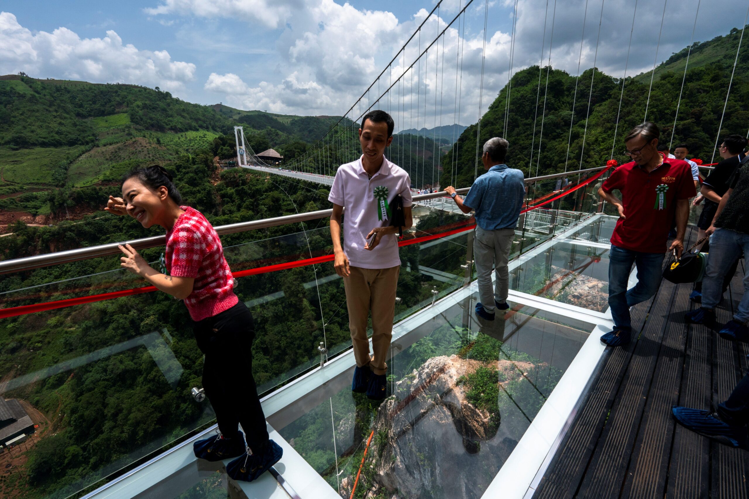 Workers clean the Bach Long glass bridge ahead of the opening ceremony at Moc Chau district in Son La province, Vietnam, May 28, 2022.