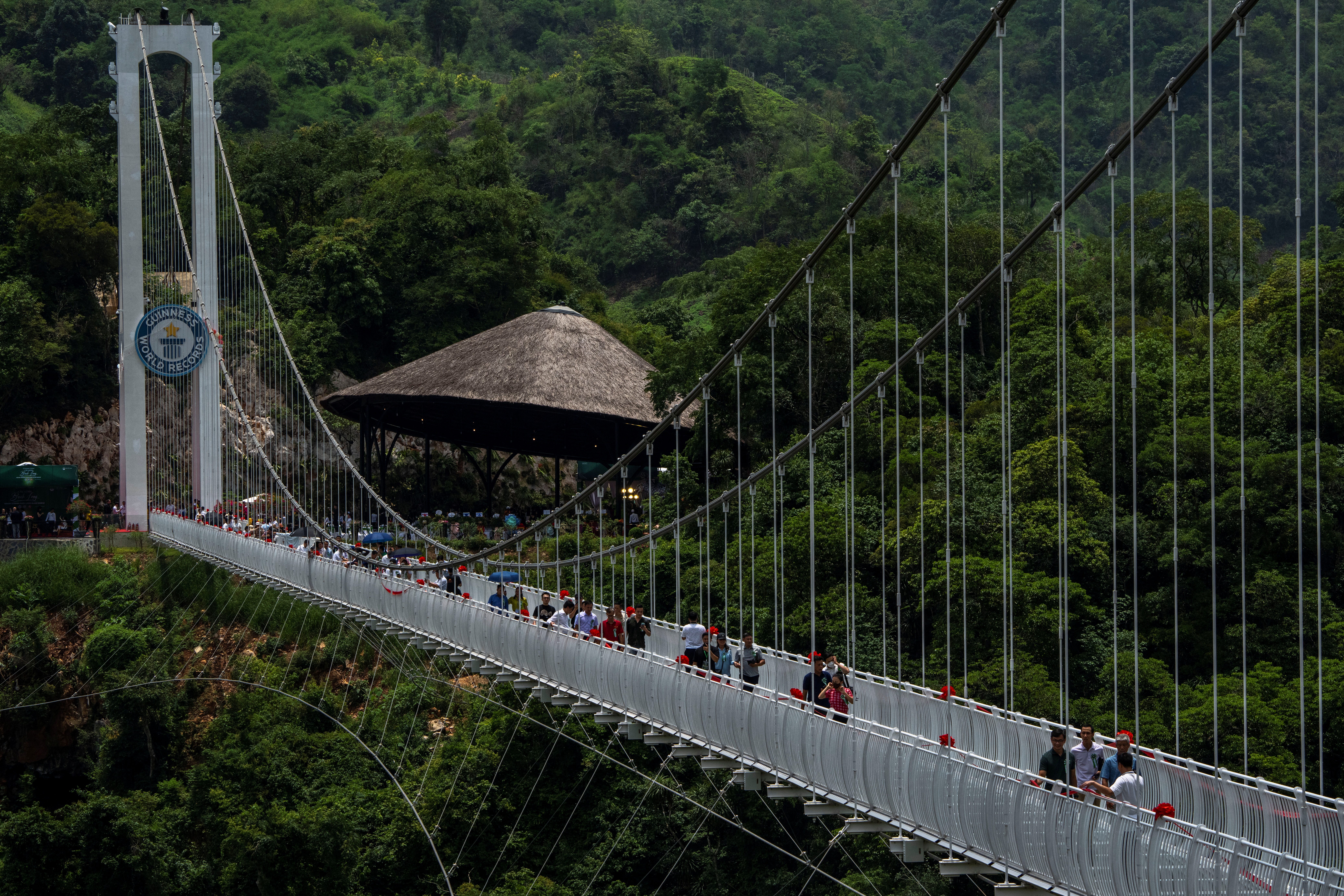 People walk on the Bach Long glass bridge during the opening ceremony at Moc Chau district in Son La province, Vietnam, May 28, 2022.