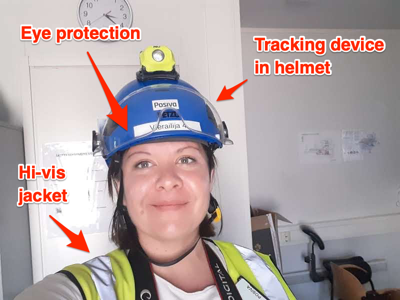Marianne Guenot wearing protective gear ahead of entering Onkalo in Eura, Finland on June 10, 2022. Arrows point to a helmet, eye protection, hi-Vis jacket.