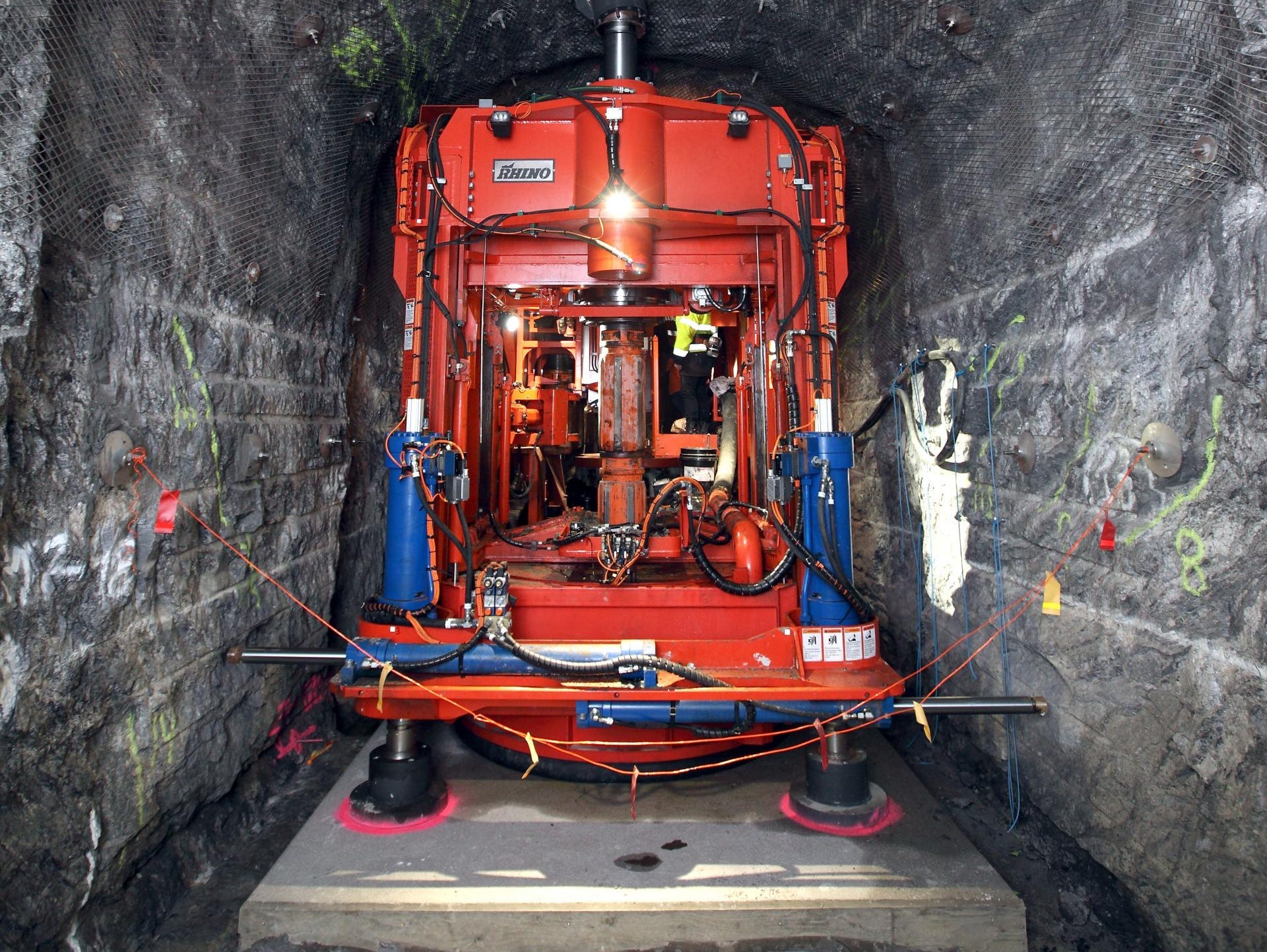 A picture of a prototype tunnel drilling machine is shown in a tunnel in Onkalo.