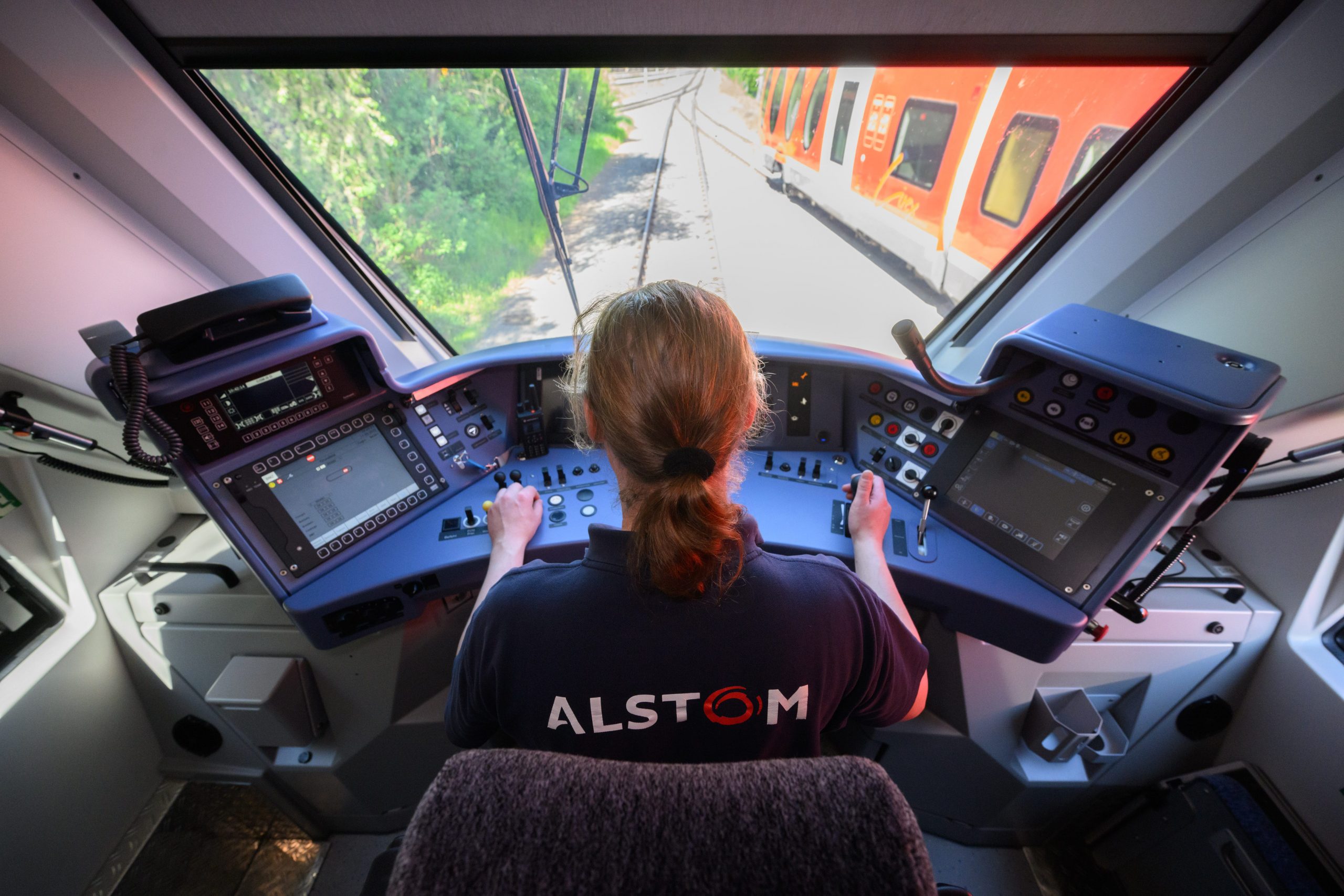 An employee of train manufacturer Alstom controls a hydrogen train Coradia iLint