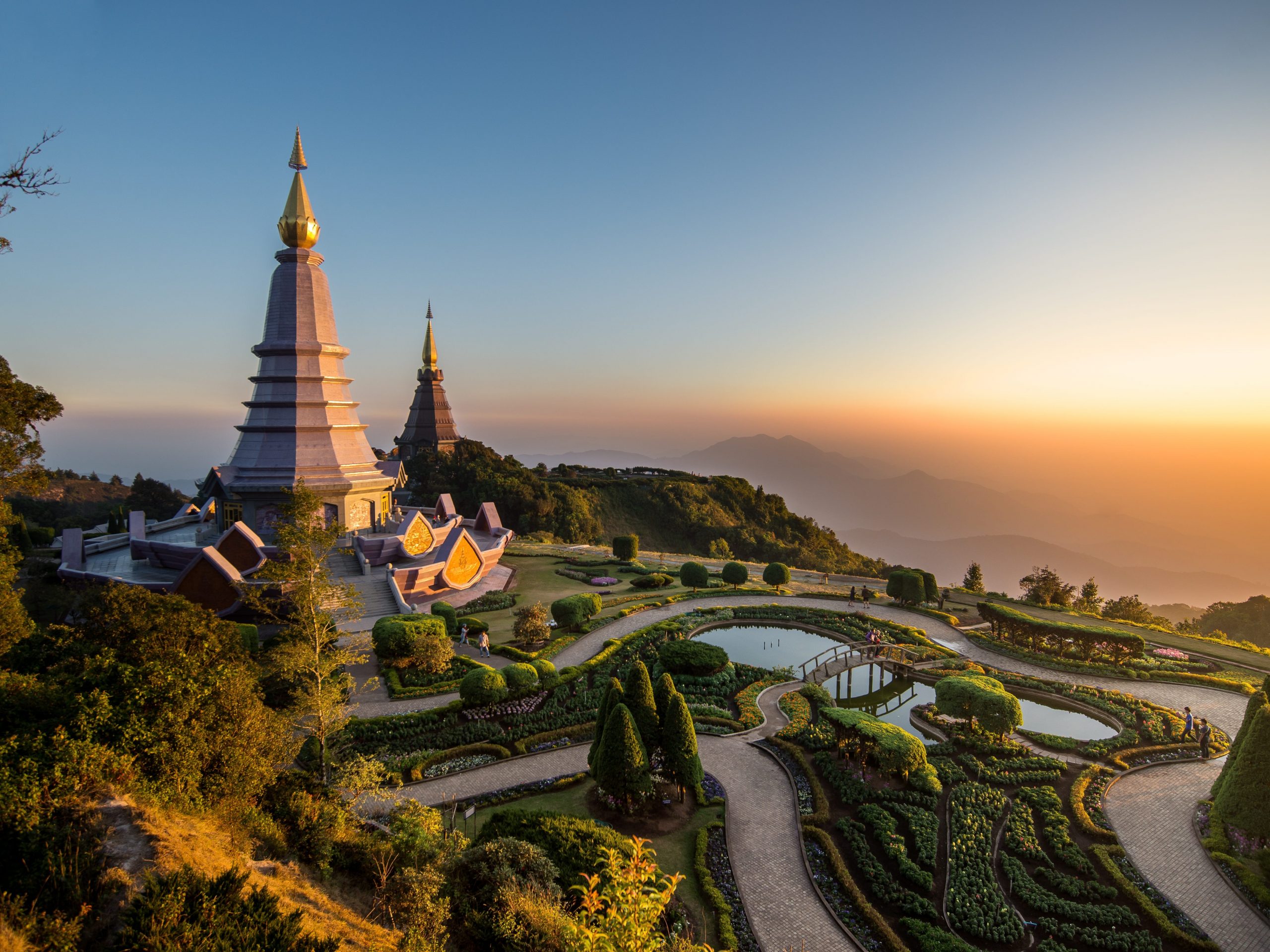 Twin pagoda monastery built on top of the mountain in the North of Thailand during sunset.