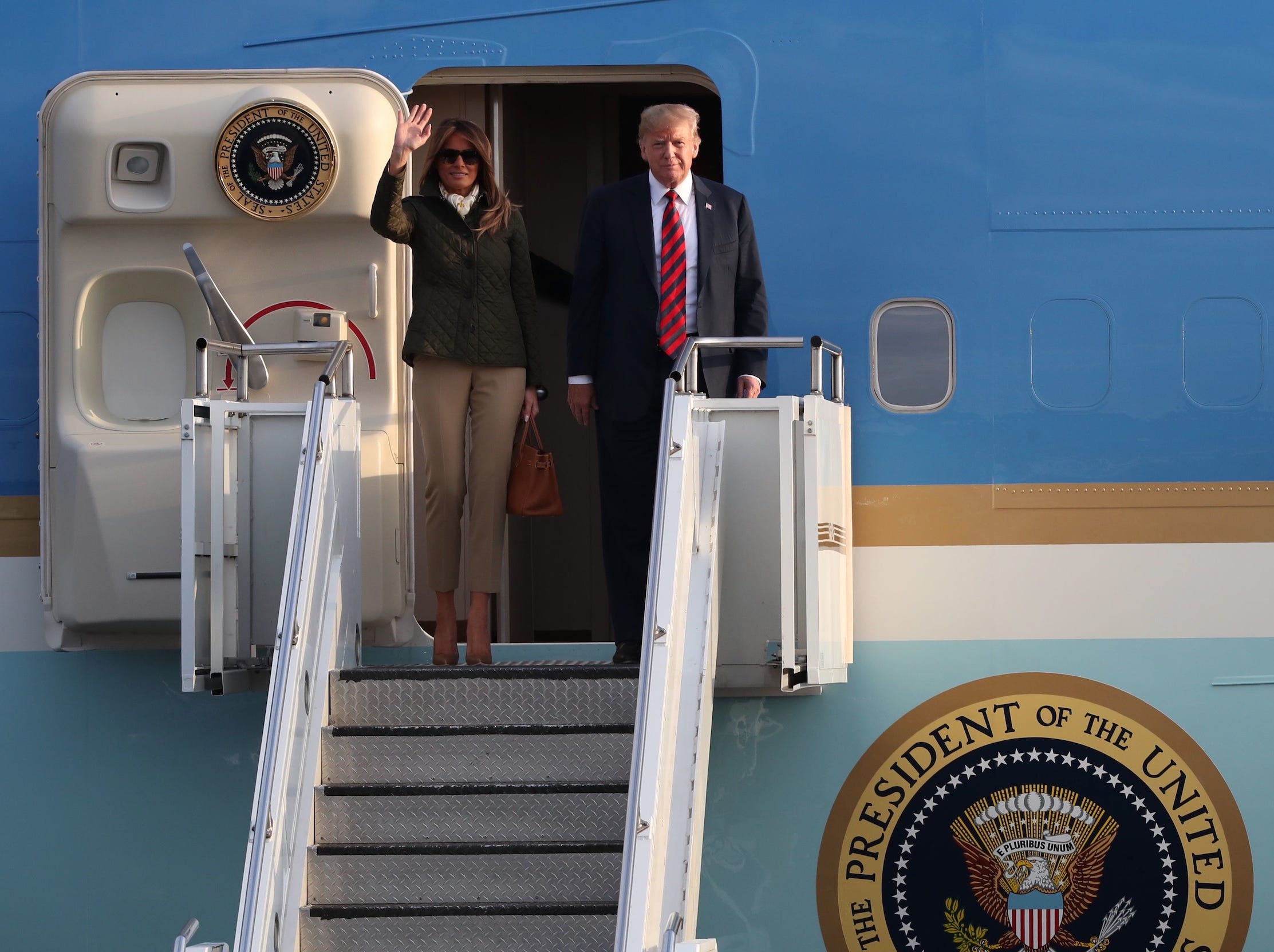 Donald and Melania Trump walking off Air Force One.