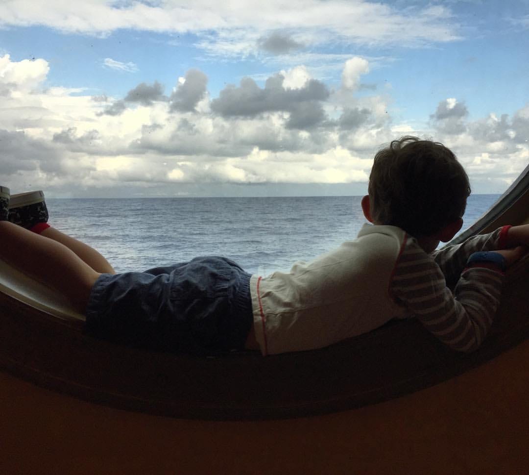 child laying down in cruise porthole