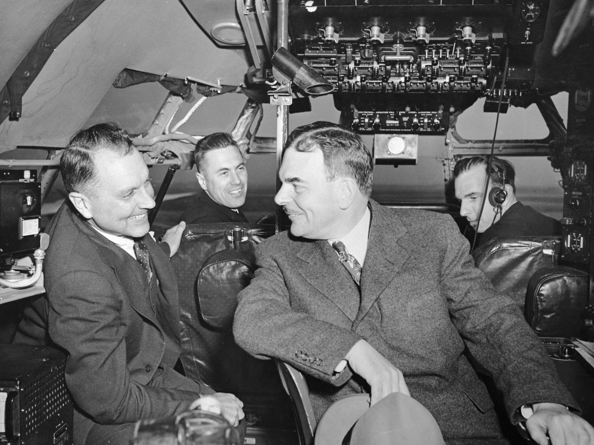 New York Governor Thomas E. Dewey (right) and Juan Trippe (left) in a Clipper cockpit with their two pilots.