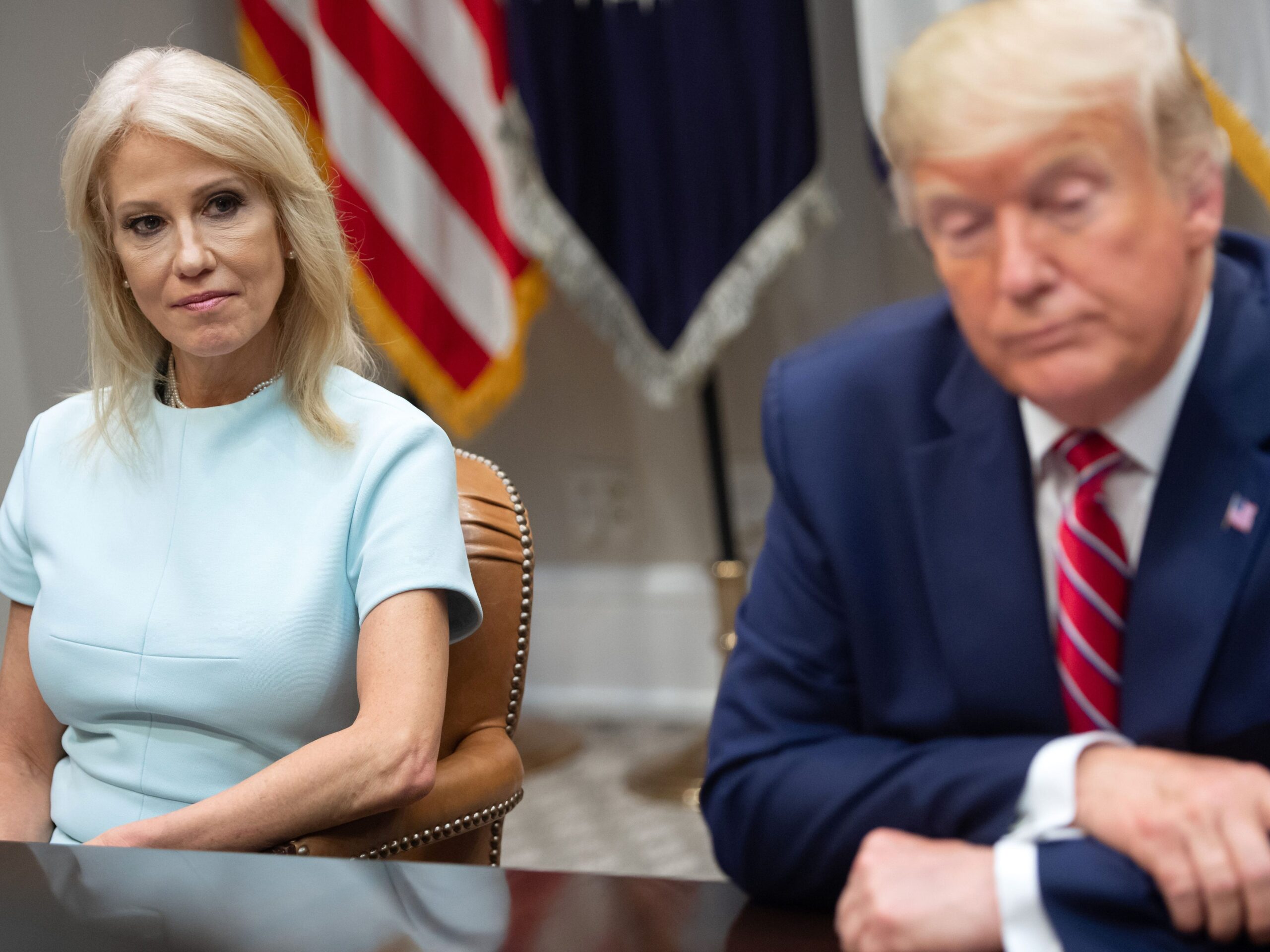 Kellyanne Conway and Donald Trump listen during a White House meeting on the opioid epidemic in 2019.