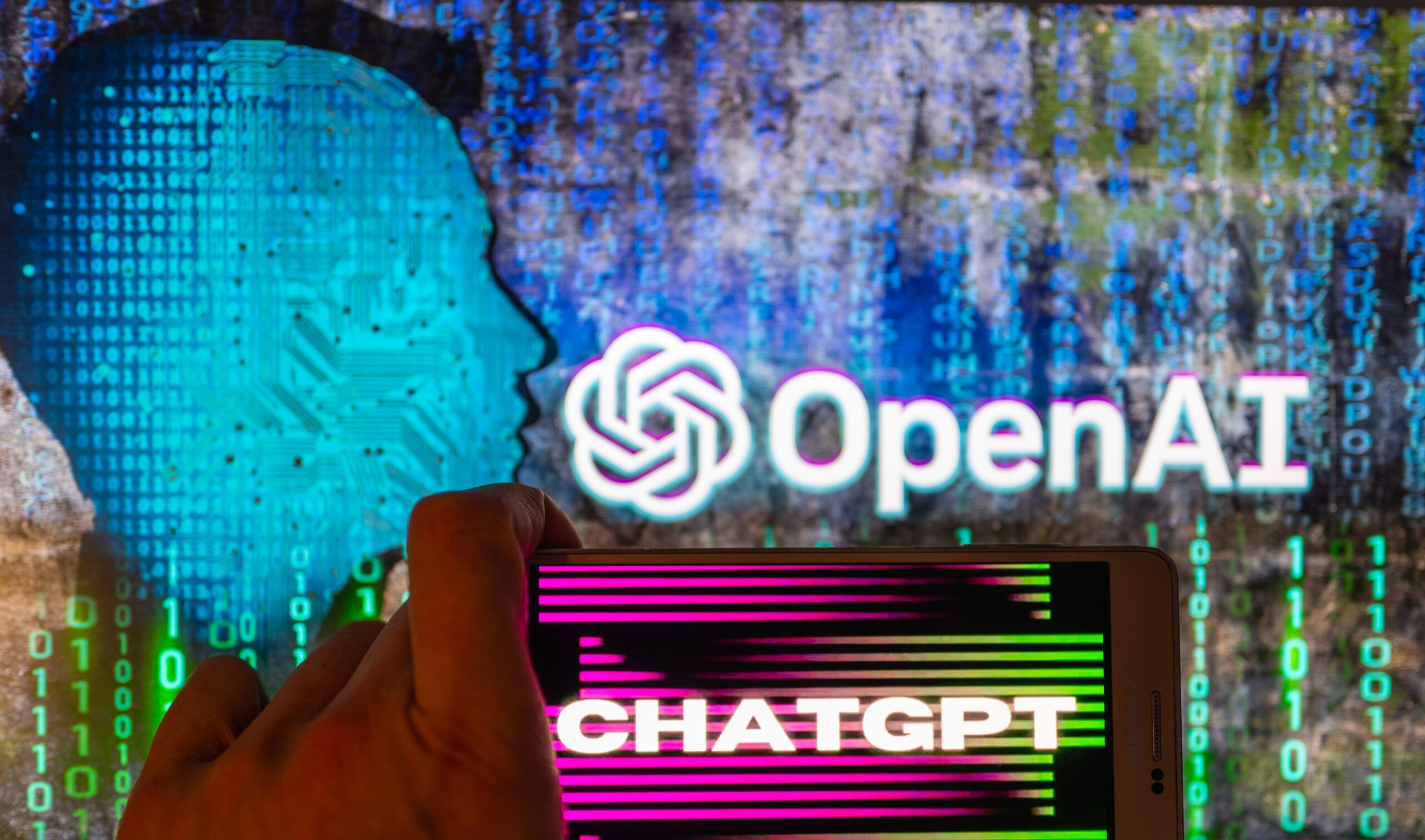 An image of a phone with ChatGPT and OpenAI&#39;s logo visible.