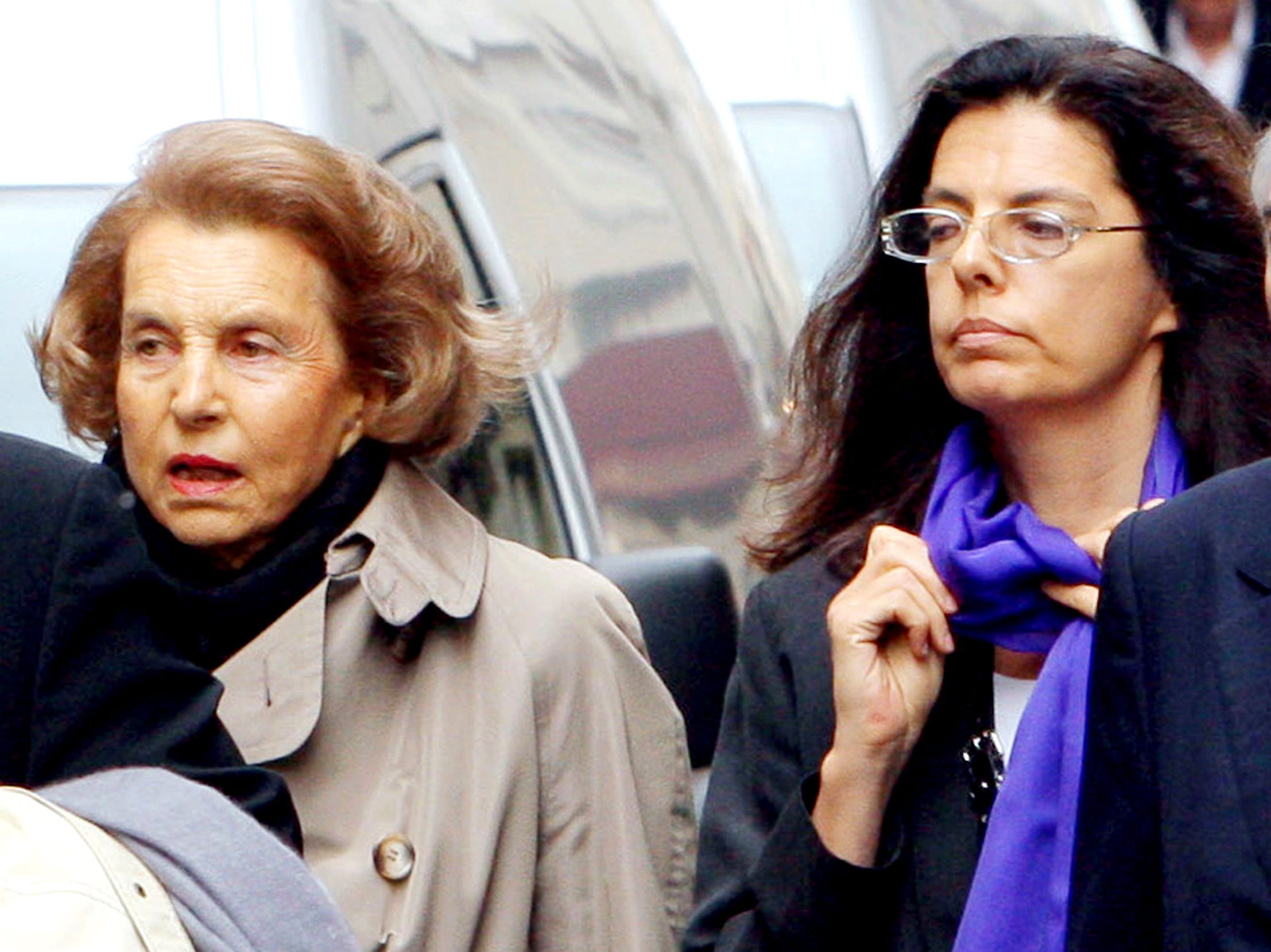 Liliane Bettencourt and her daughter Francoise Bettencourt-Meyers walk next to car