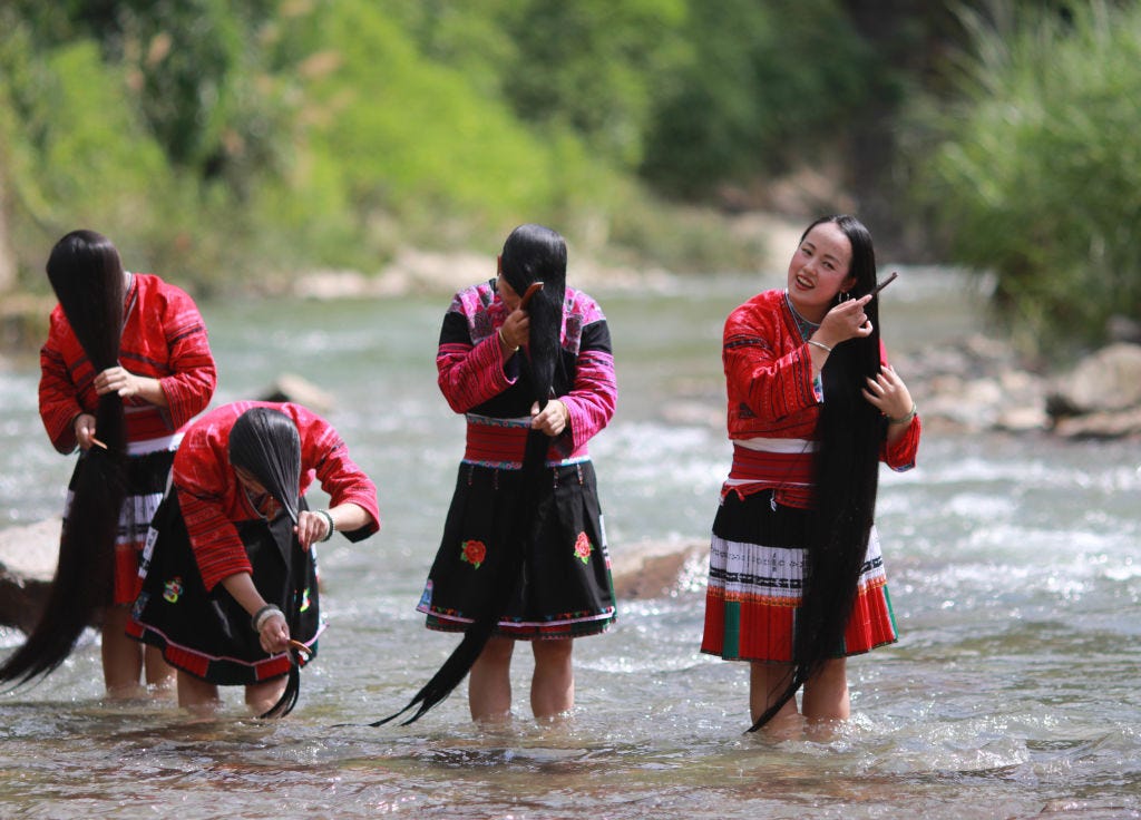 Red Yao women washing their hair in the Jinsha River.