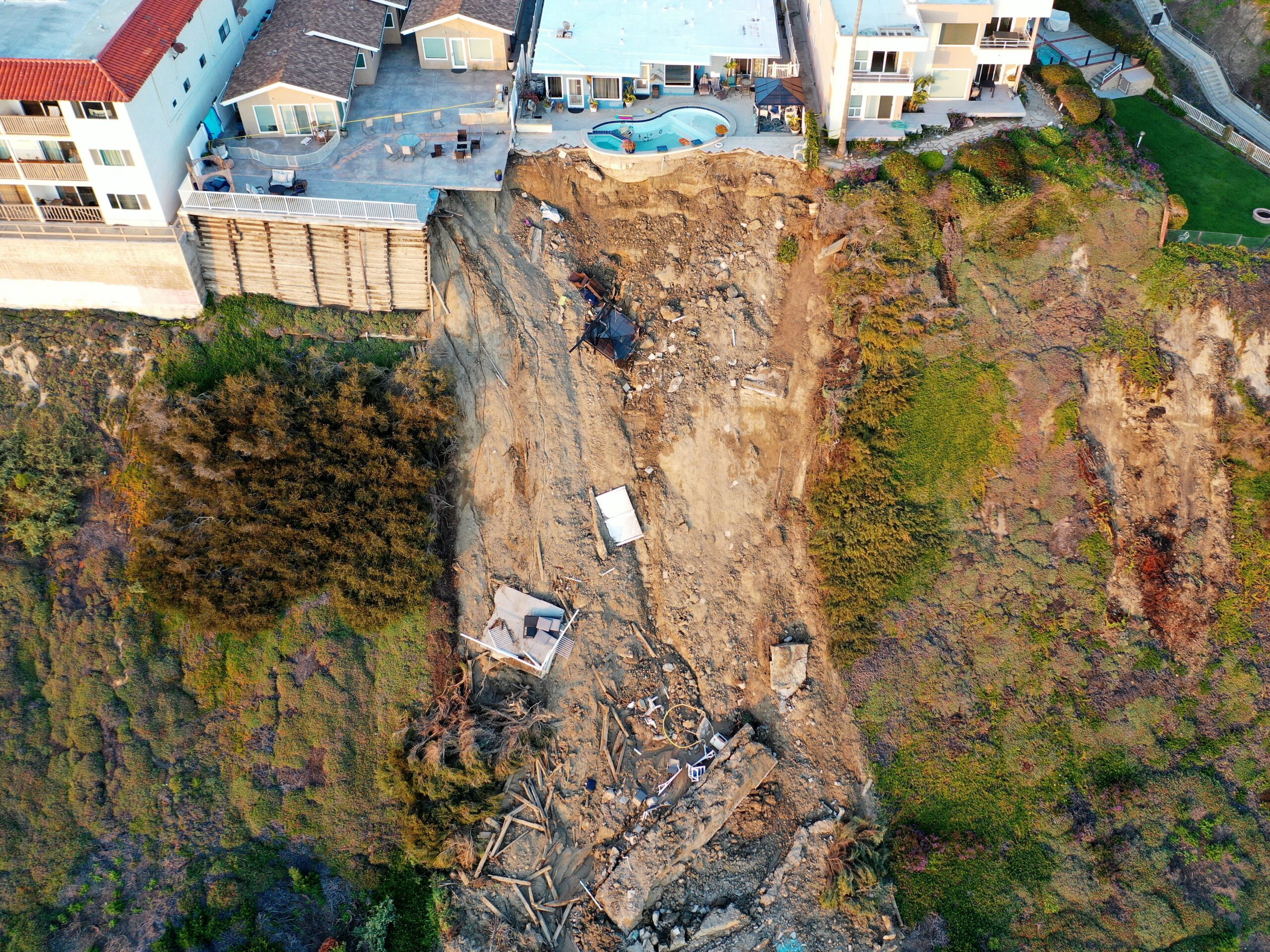 Heavy rain and landslides in California left part of a backyard