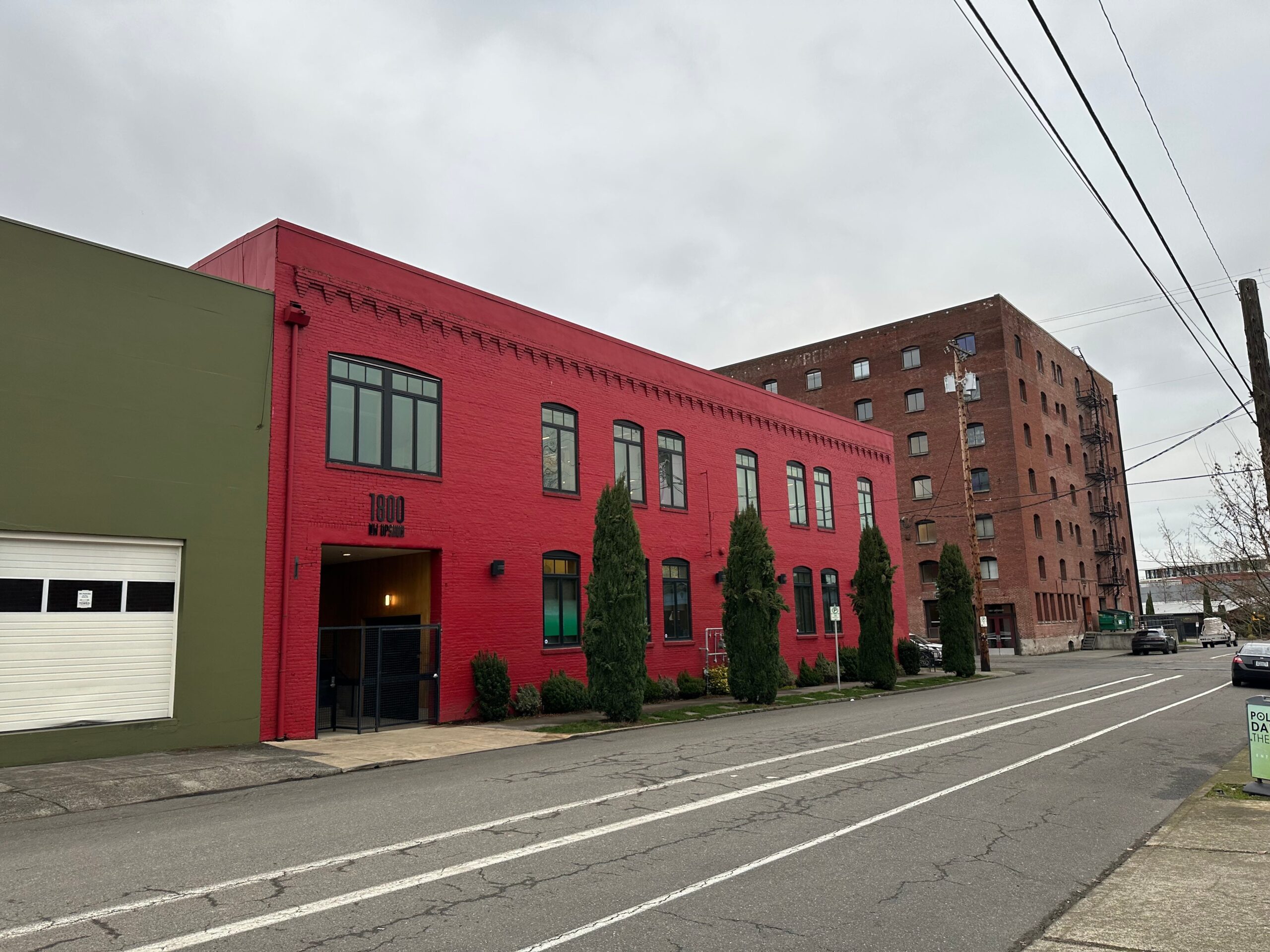 Allbirds&#39; office, a red building on a city street in Portland, Oregon.