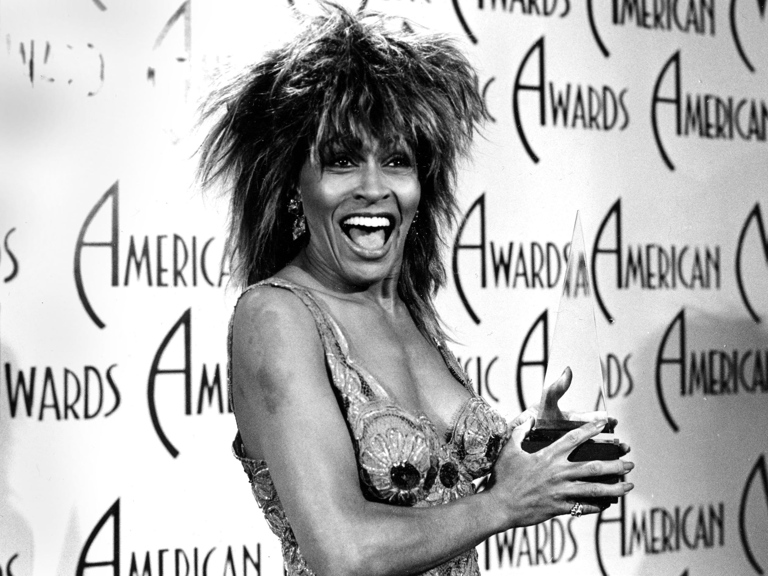 Tina turner poses with her award backstage at the 12th annual American Music Awards at the Shrine Auditorium in Los Angeles, Calif., January 28, 1985