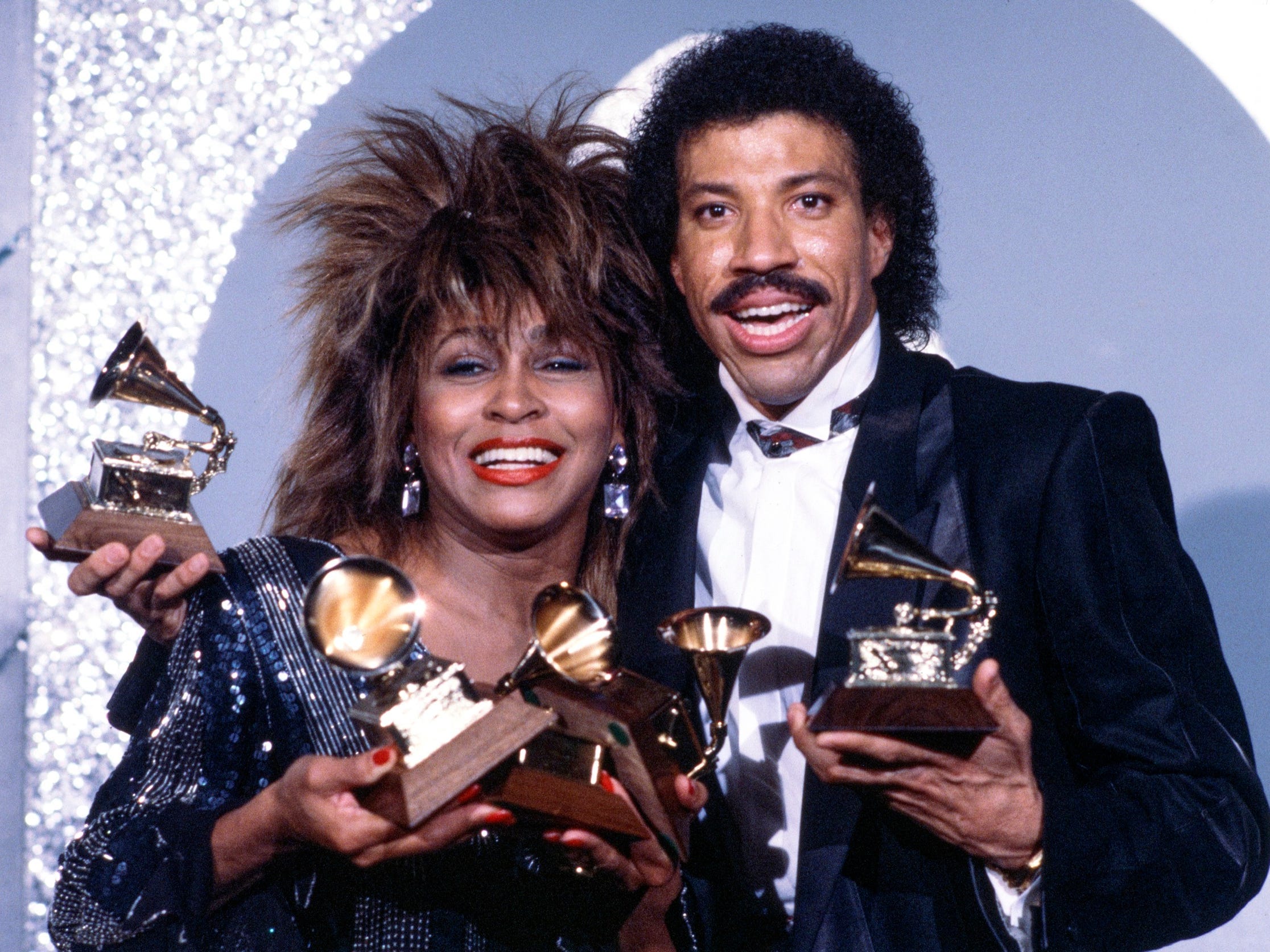 LOS ANGELES - FEBRUARY 26: Pictured from left is Tina Turner and Lionel Richie on THE 27TH ANNUAL GRAMMY AWARDS, February 26, 1985, Shrine Auditorium, Los Angeles, CA.