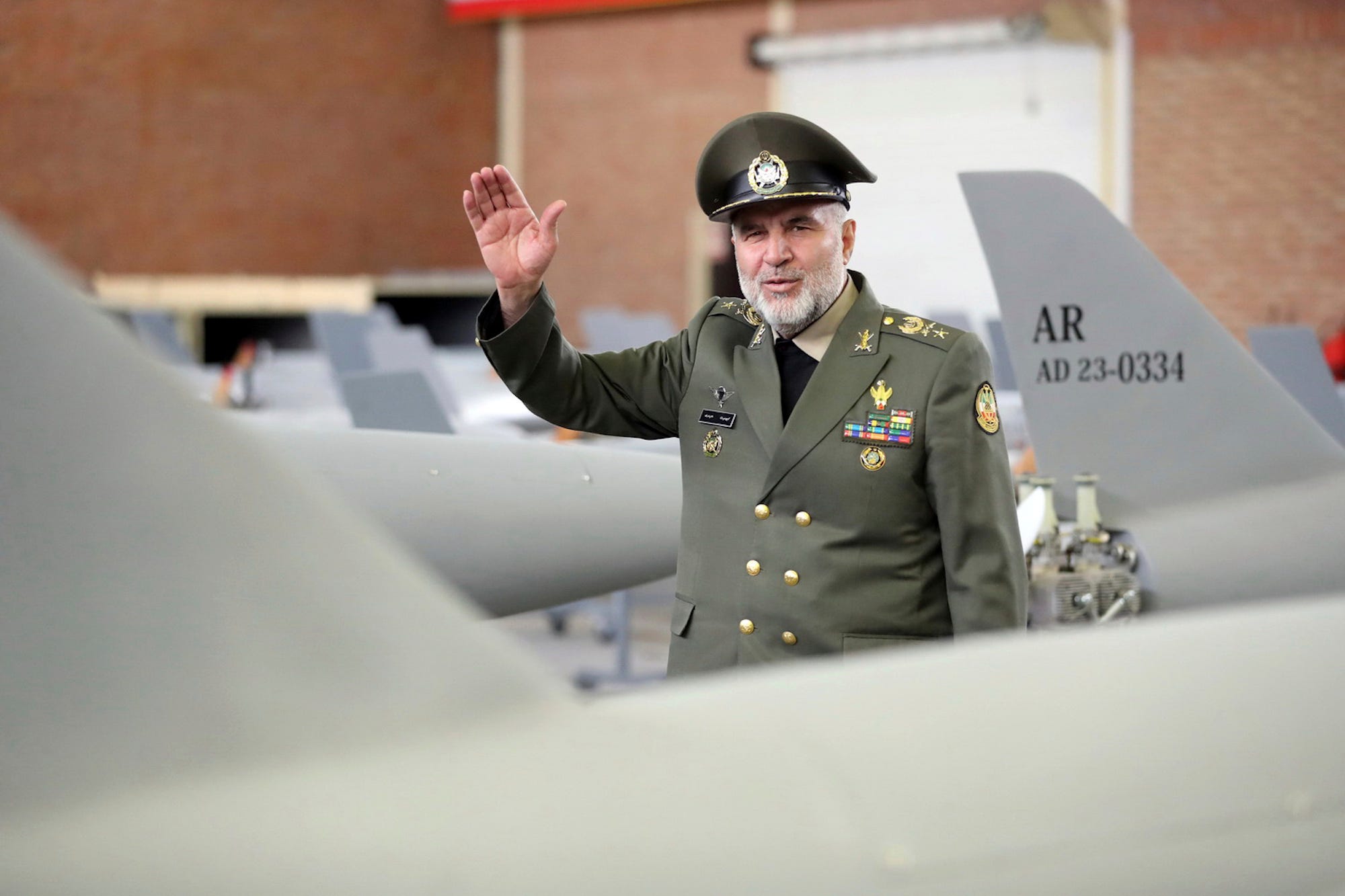 Commander of the Iranian Army&#39;s Ground Force Gen. Kioumars Heidari waves among Iran-made drones in a picture released by Iran’s army on April 20, 2023.