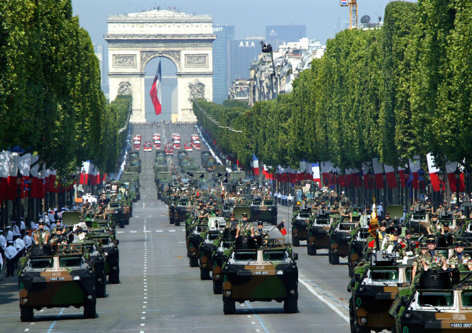 Armoured cars drive down the Avenue des Champs Elysees in Paris July 14, 2005 during the annual Bastille Day parade.
