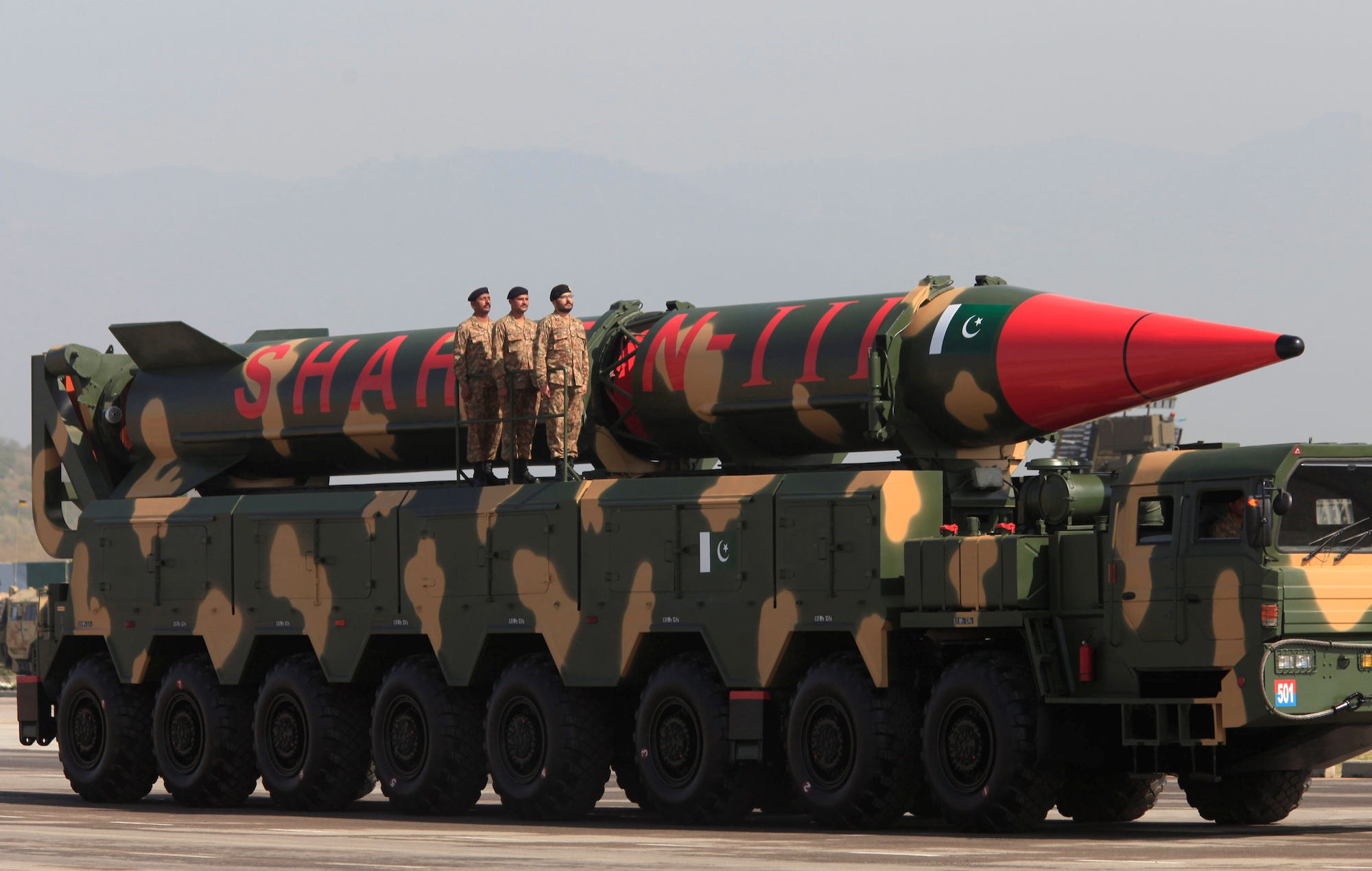 Pakistani military personnel stand beside a Shaheen III surface-to-surface ballistic missile during Pakistan Day military parade in Islamabad, Pakistan, in March 2017.