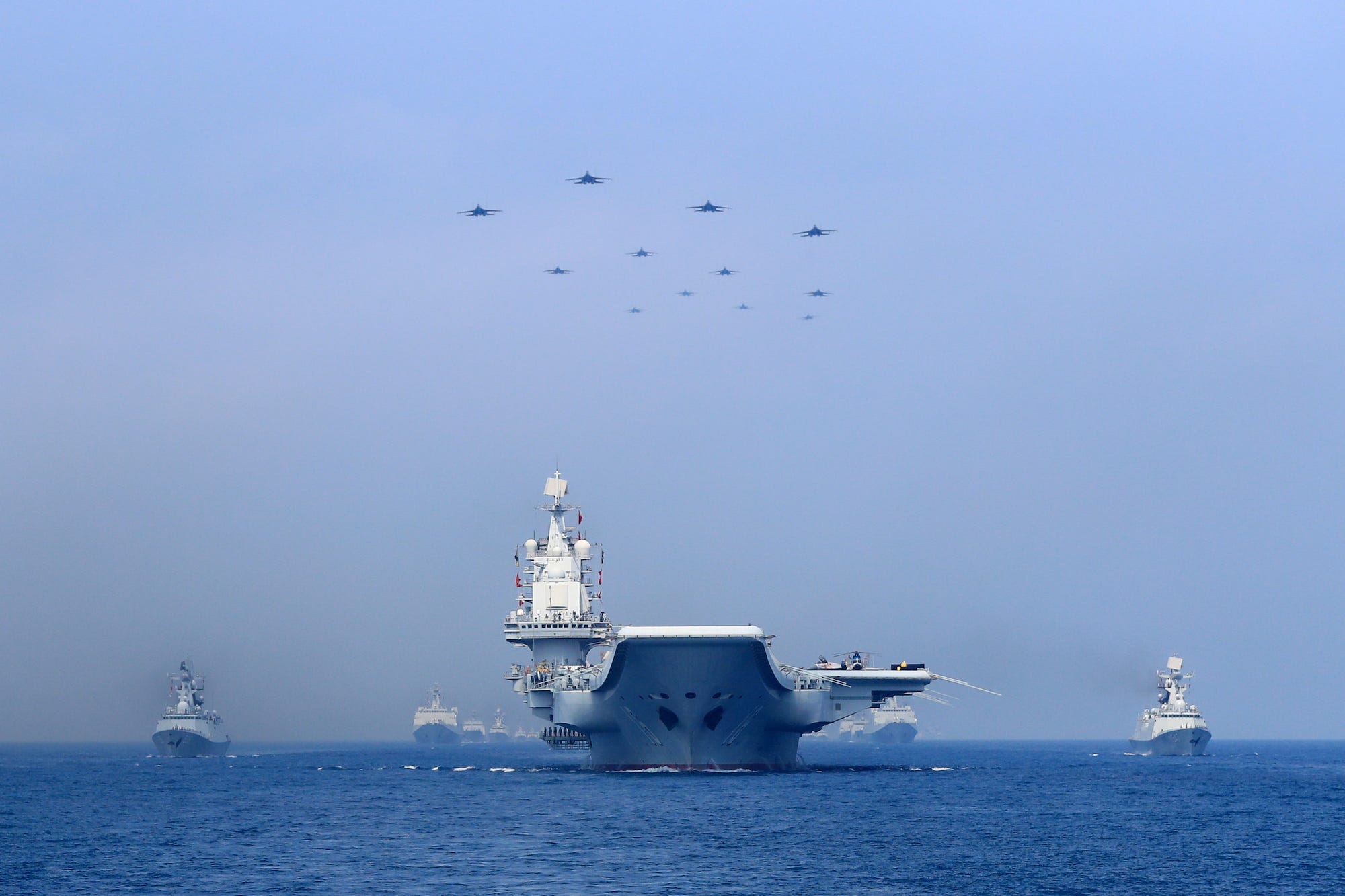 Warships and fighter jets of Chinese People&#39;s Liberation Army (PLA) Navy take part in a military display in the South China Sea in April 2018.