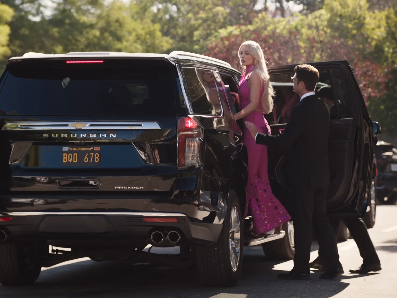 Margot Robbie&#39;s Barbie getting into an SUV in &#34;Barbie.&#34;