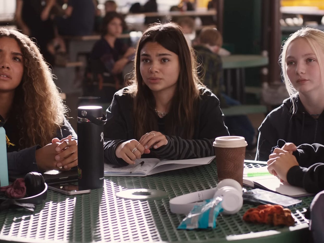 Sasha (Ariana Greenblatt) and her friends sitting at a lunch table in &#34;Barbie.&#34;