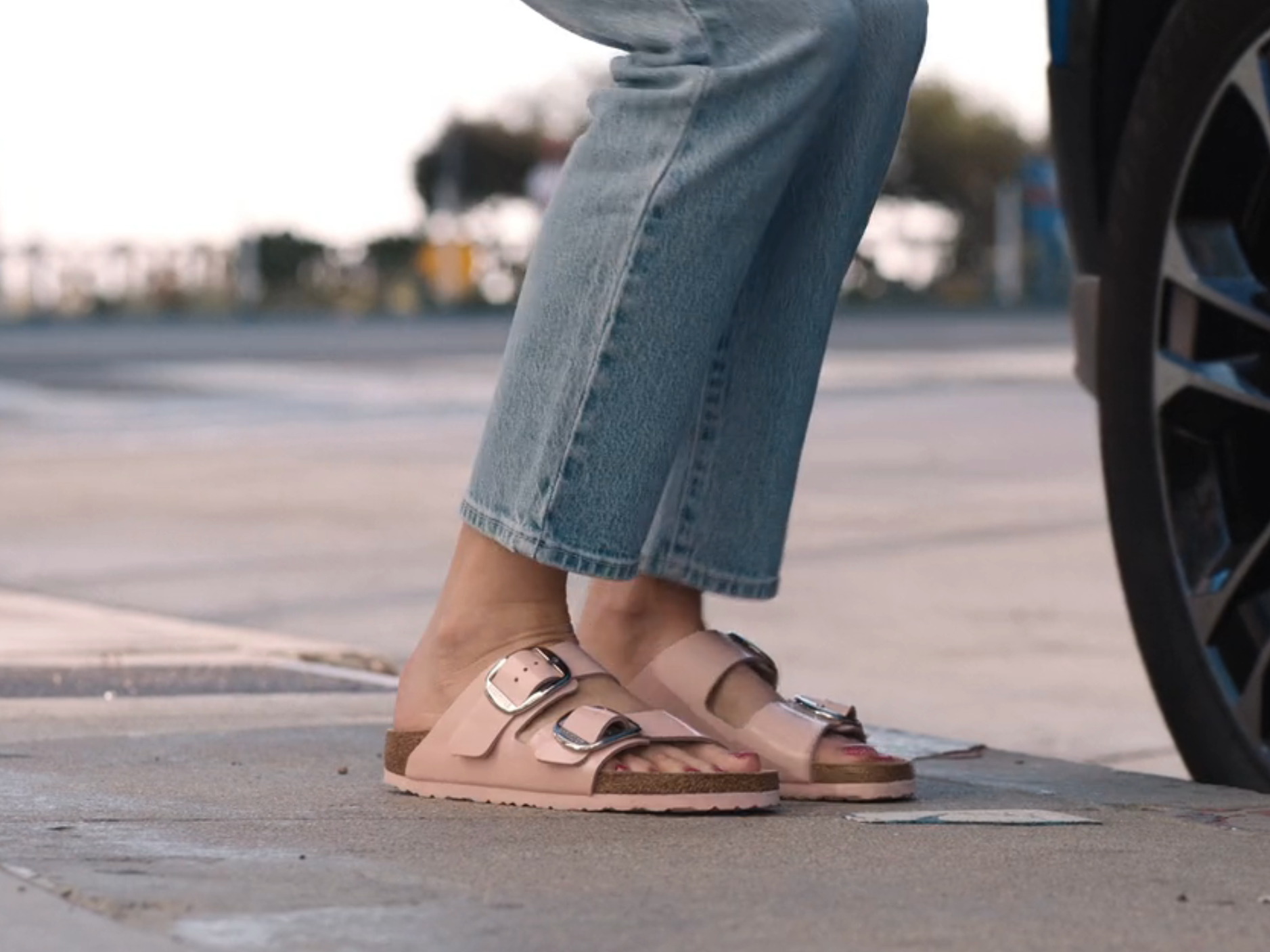 barbie&#39;s feet as she steps out of a car, she&#39;s wearing birkenstocks