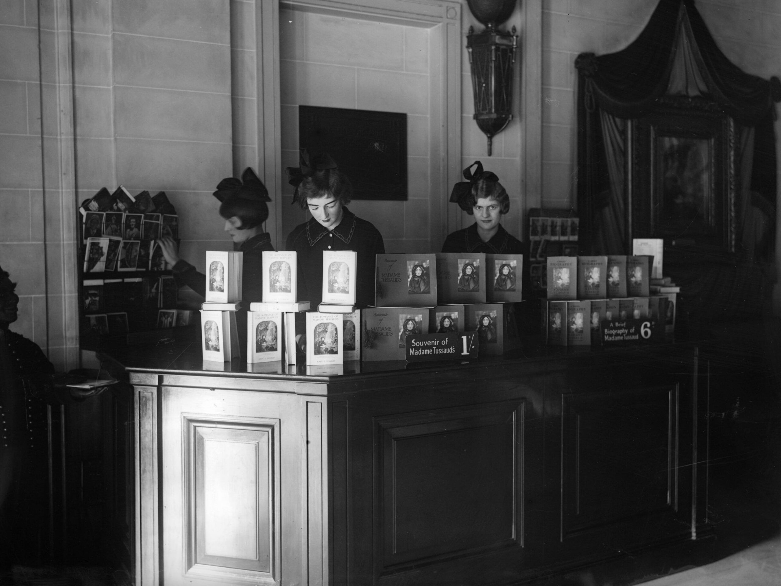 circa 1930: Sales assistants in the souvenir bookshop at Madame Tussaud&#39;s, London.