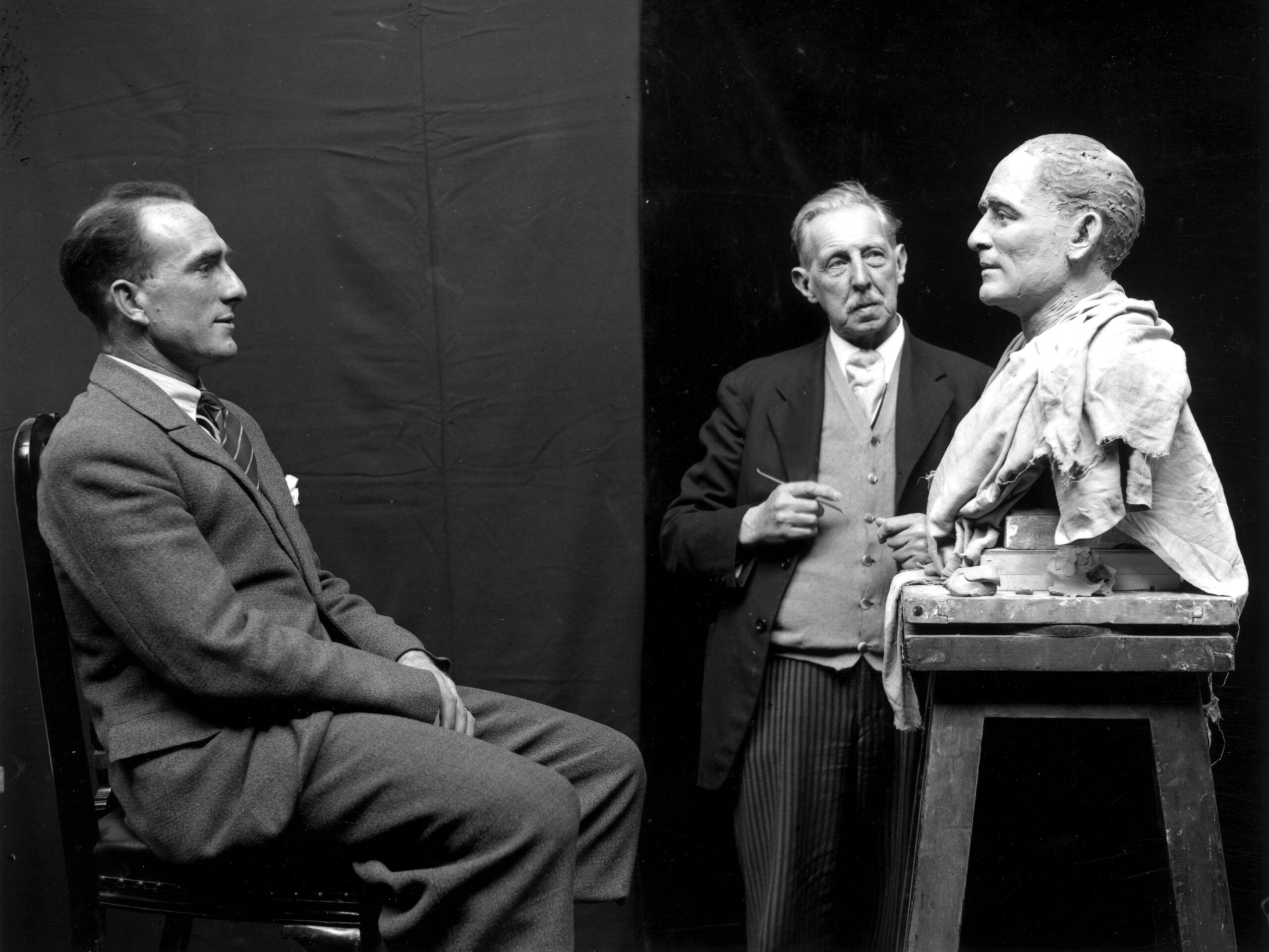 22nd April 1930: Footballer Tom Parker, captain of Arsenal, sitting for waxwork maker John Tussaud, who is crafting his likeness for a model at Madame Tussaud&#39;s.