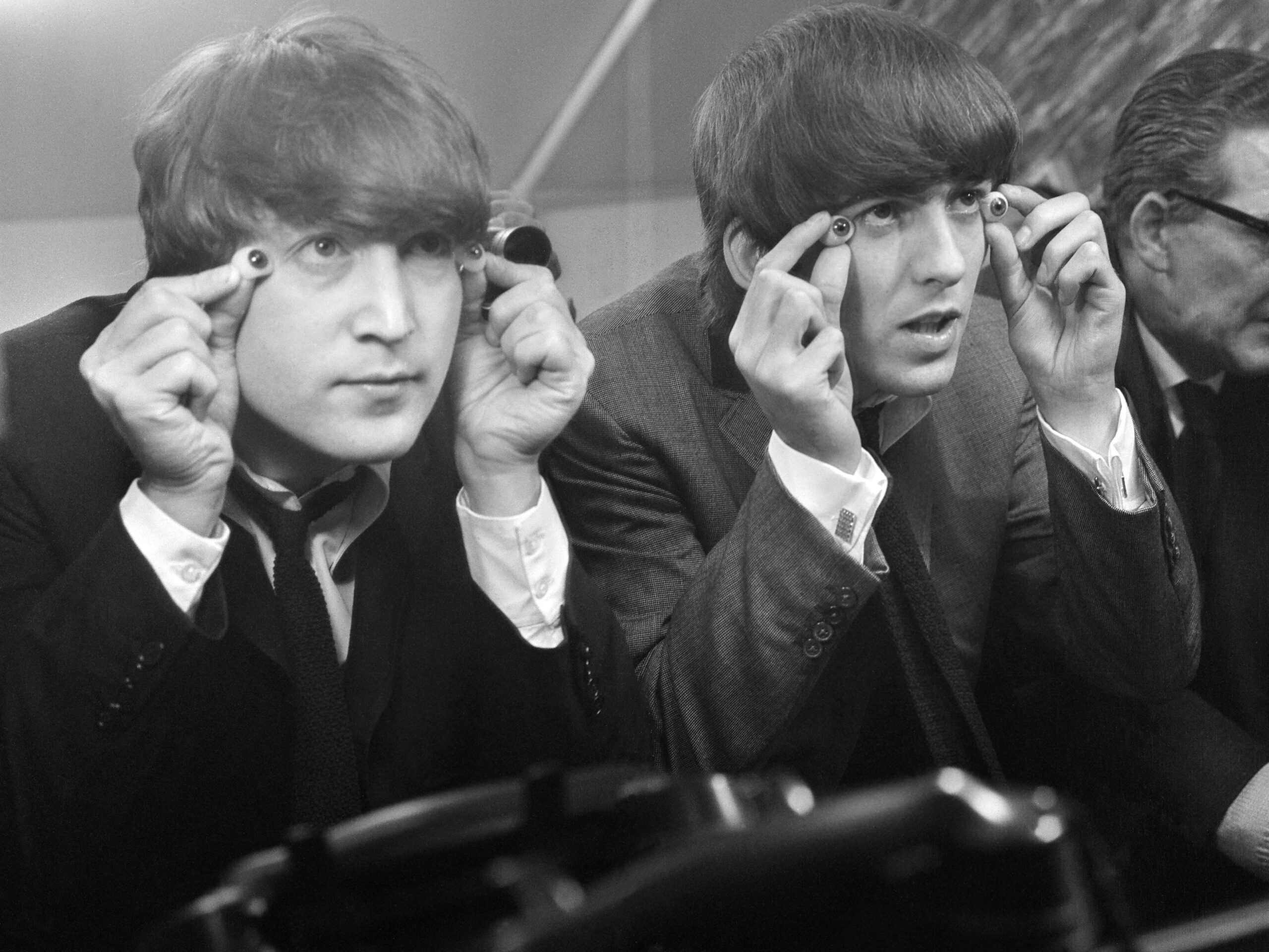 John Lennon and George Harrison with glass eyes when the Beatles&#39; details were being taken for their Madame Tussauds waxworks during the making of &#34;A Hard Day&#39;s Night&#34;, Twickenham Film Studios, 12 March 1964.