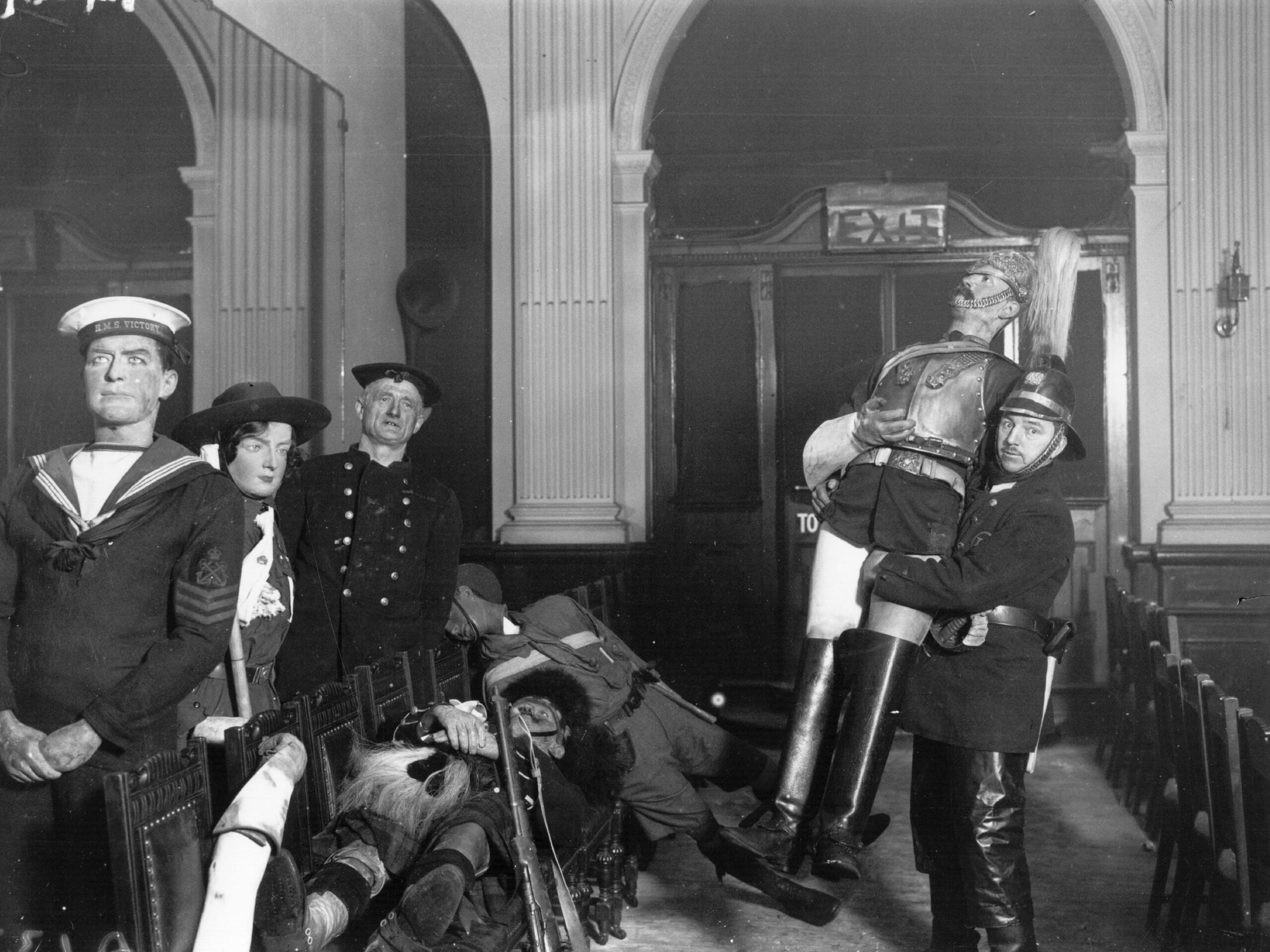 A fireman with some of the wax figures that were saved, after the fire at the famous waxworks, Madame Tussaud&#39;s in London	March 01, 1925