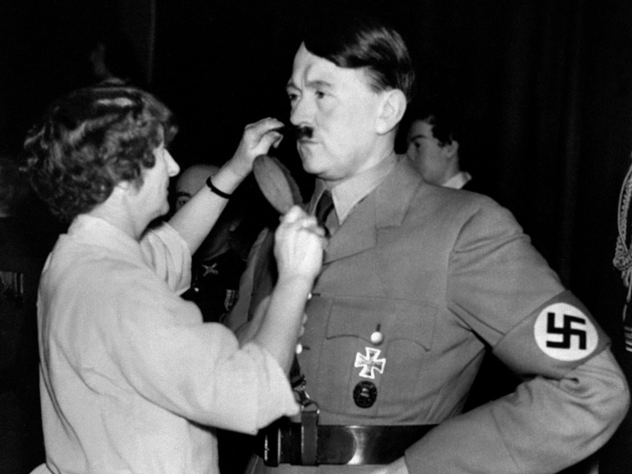 A picture taken on November 24, 1938 shows the wax figure of German Nazi Chancellor Adolf Hitler having his moustache combed by a hairdresser at Madame Tussauds Wax museum in London.