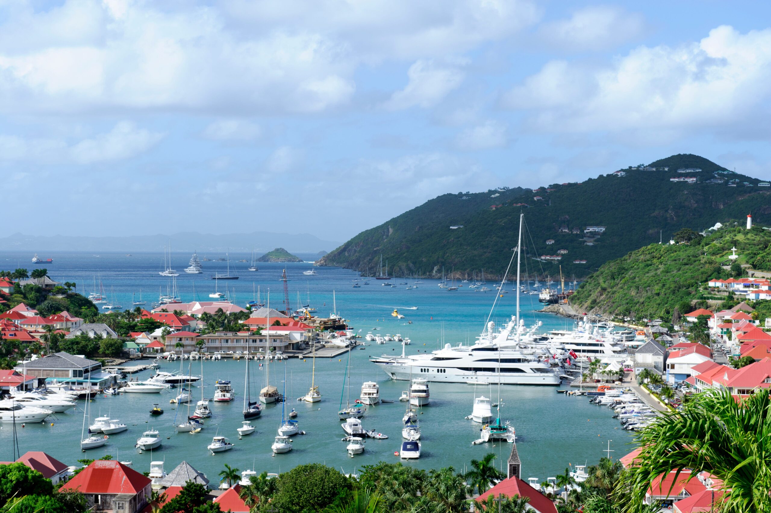 A St. Barts harbor with several smaller boasts and some bigger yachts.