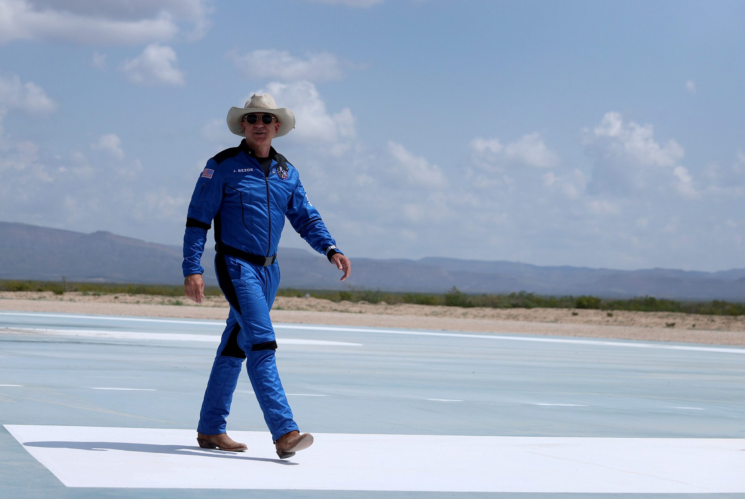 Jeff Bezos wearing a cowboy hat and blue Blue Origin jumpsuit