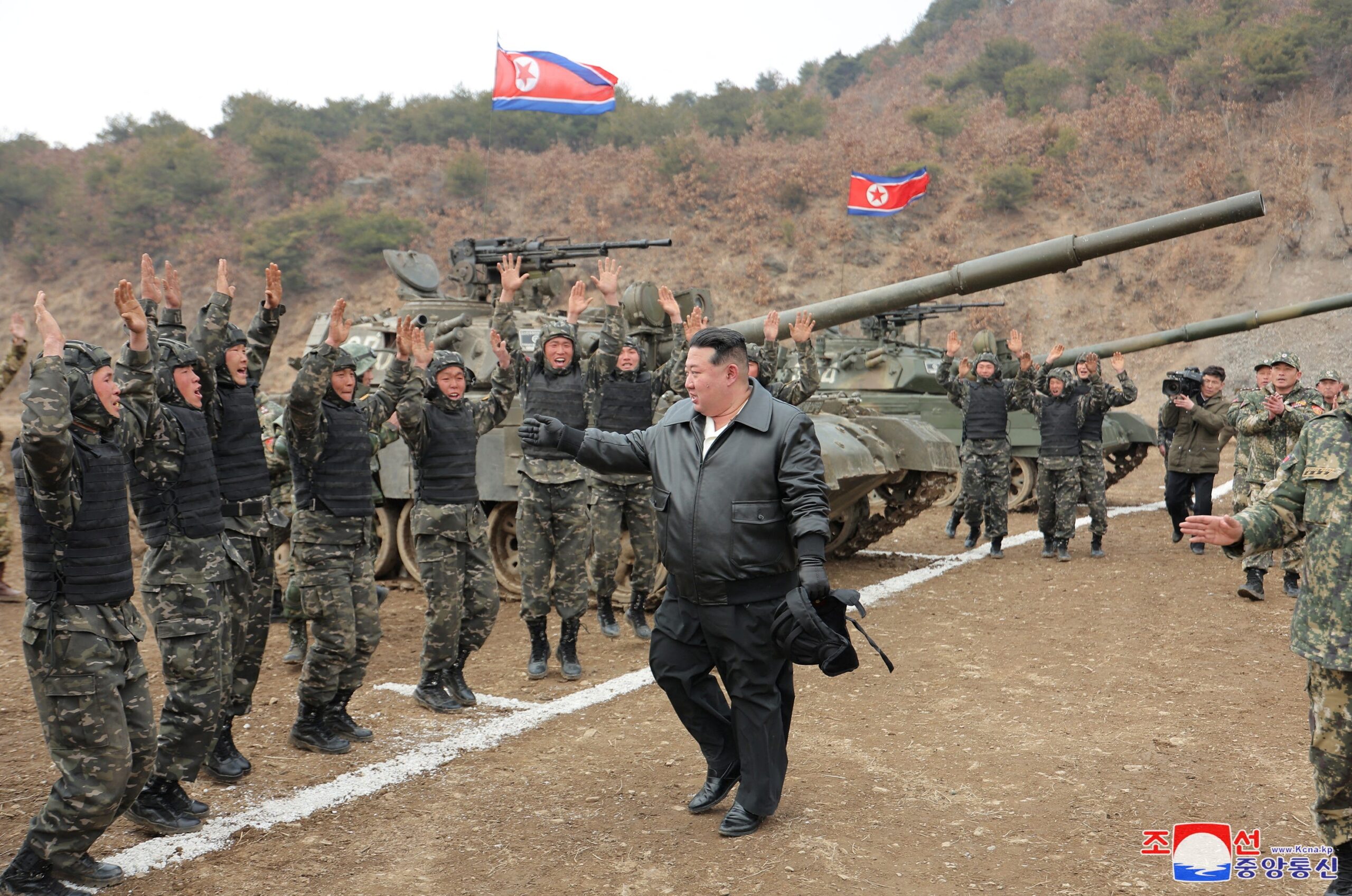 North Korean leader Kim Jong Un gestures at soldiers during a military demonstration