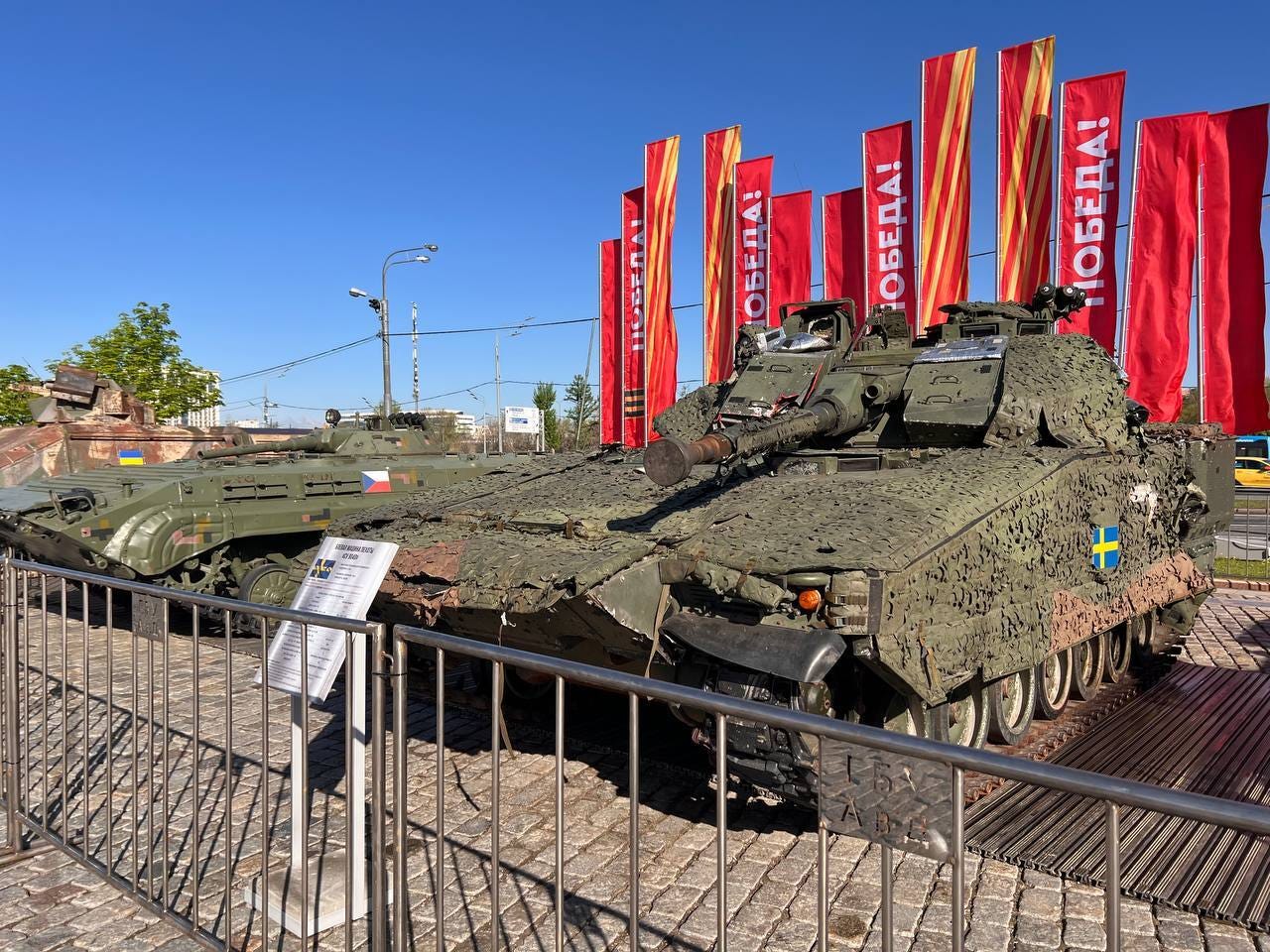 A Swedish-made CV90 is seen behind a fence.