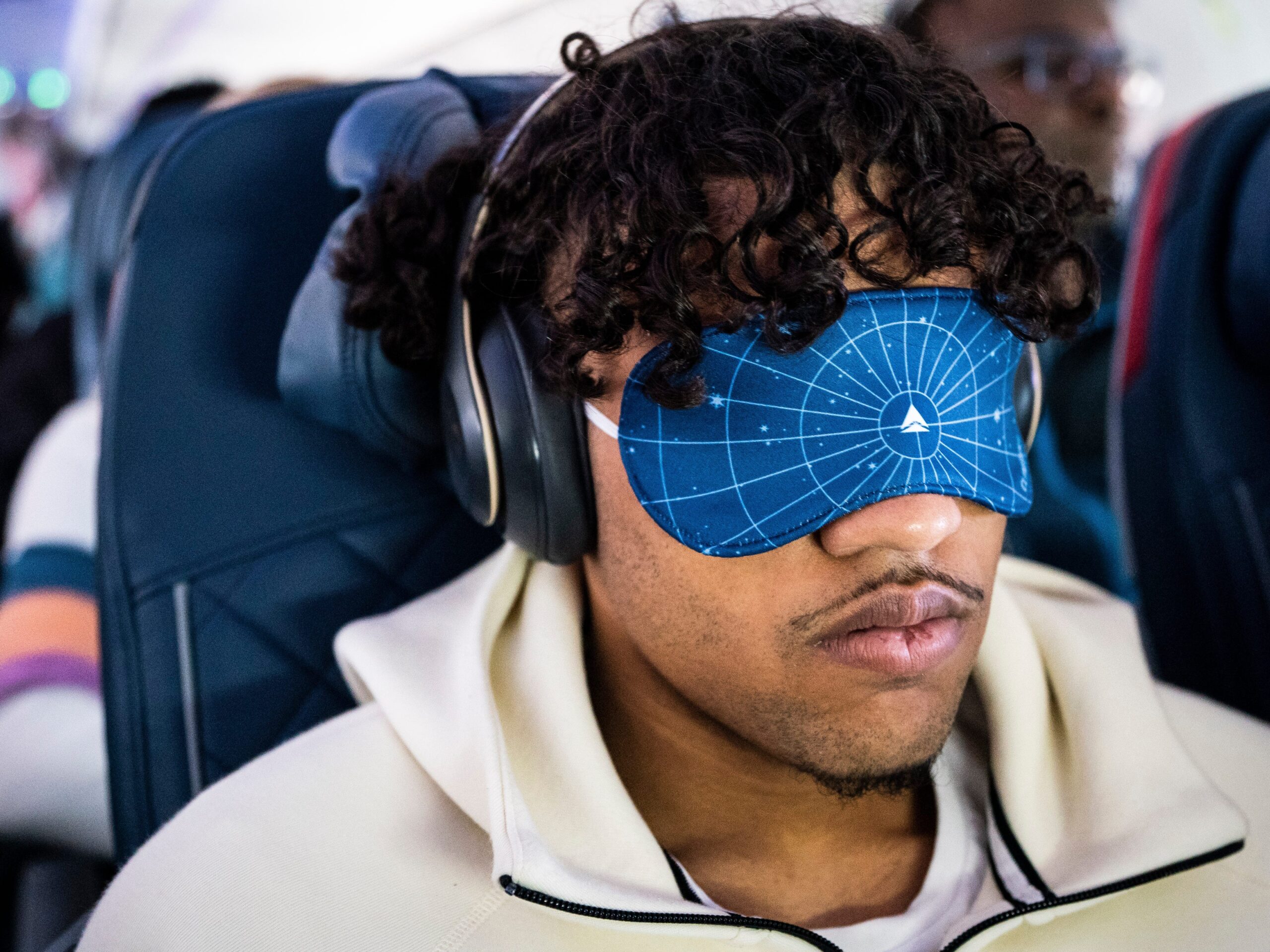 A passenger wear his special edition eye mask during a path of totality Delta Airlines flight from Dallas to Detroit, at Dallas Fort Worth International Airport.