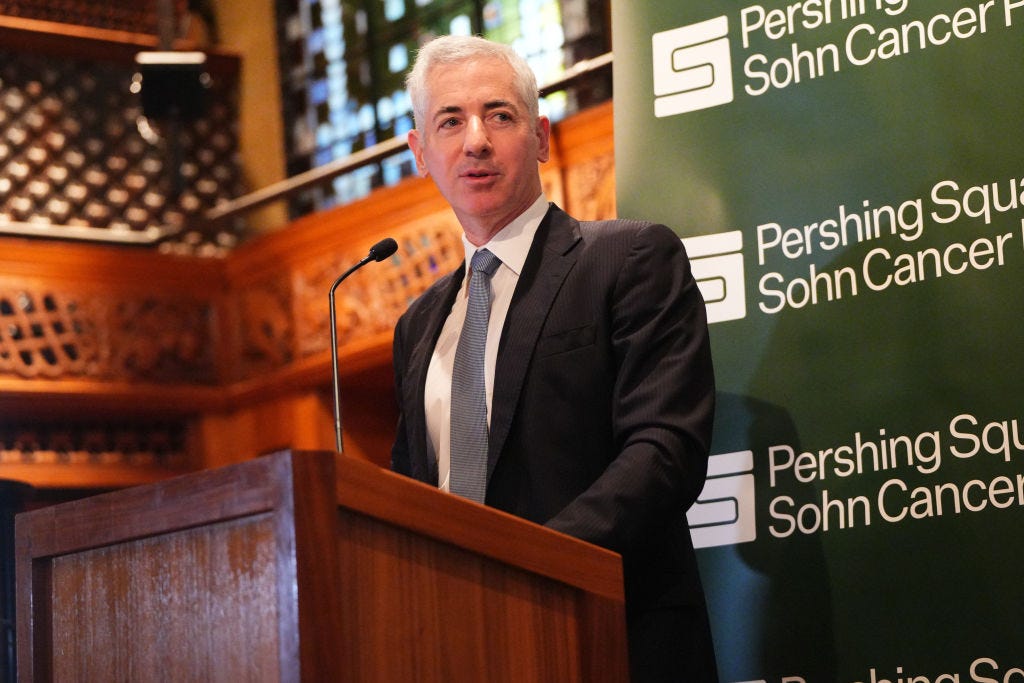 Bill Ackman in a suit and tie standing at a lectern.